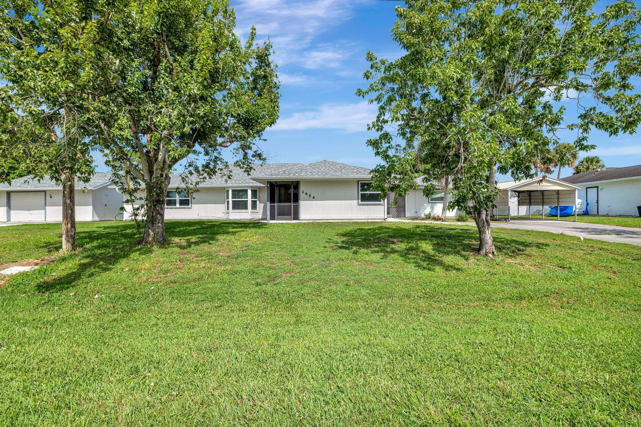 Ranch style home with 2 separate Living Area on a half acre lot size. The main house (2614 sq. ft.) has 3 bedrooms, 2 bathrooms, w/master bedroom having 2 walk-in closet, shower, tub and dual sink and 2nd bedroom with a den. The 2nd living area is a Mother-In-Law Suite (670 sq. ft.) with kitchen, living/dining, bedroom, bathroom and private side entrance. The main house has a beautiful hand painted mural in the living area with a stone wall design. There are 5 sky lights. List of recent updates includes new roof (2023), 3 new AC (2016-2020), new hurricane proof windows (2023), chained- link fence (2019), outdoor patio new screen (2021), remodeled bathrooms (2016), and 2 separate driveways. This property will need some additional update that will includes new flooring and kitchen.