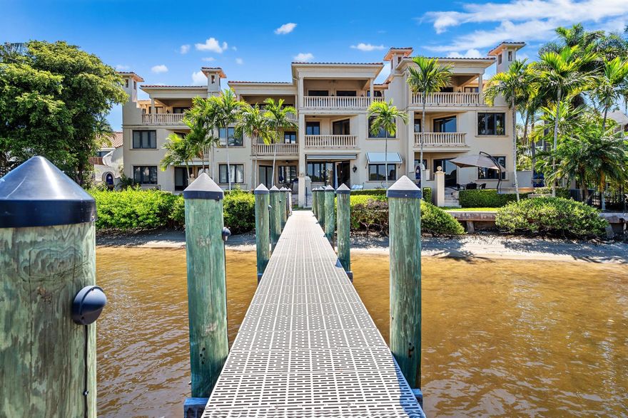 Direct Intracoastal townhome at Ocean Ridge Yacht Club features a dock that can accommodate a 40-foot vessel. Details include a three-story foyer with a floating staircase and elevator, a chic great room adjacent to the chef's kitchen, luxe primary suite, a family room with a wet bar, multiple Intracoastal-view balconies, and outside areas that include a loggia, summer kitchen, and spa.