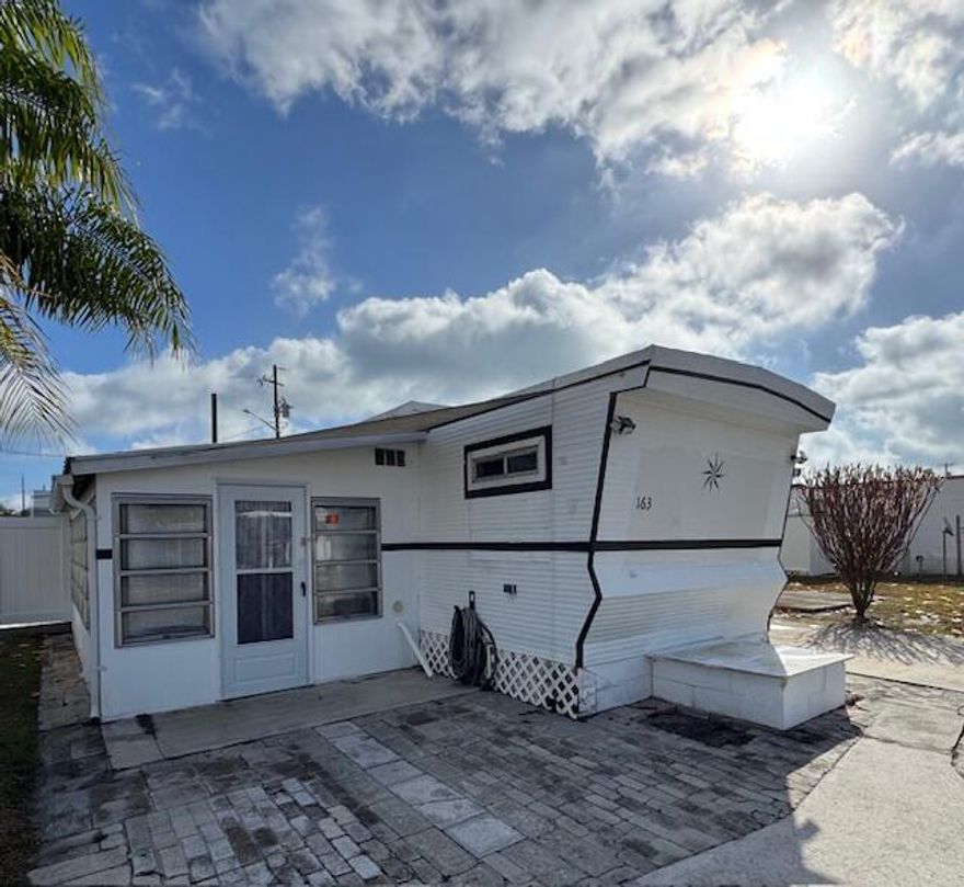 Don't miss this excellent value in the desirable Whispering Creek 55+ CO-OP community...featuring $0 lot lease and super low monthly fee - $255. This spacious, beautifully updated and well-maintained manufactured home is turnkey and being sold fully furnished. Conveniently located one block from the clubhouse and pool,  just minutes to downtown Fort Pierce and the area's blue-water beaches.
This charming 1-bedroom, 1-bath home also offers an extended Florida room, currently utilized as a guest bedroom/bonus space. Additional highlights include a covered carport, an oversized private fenced patio (the only one of its kind in the community), and a large, sturdy, anchored storage shed for extra storage. Schedule your showing today and see for yourself, one of the best values in the park!