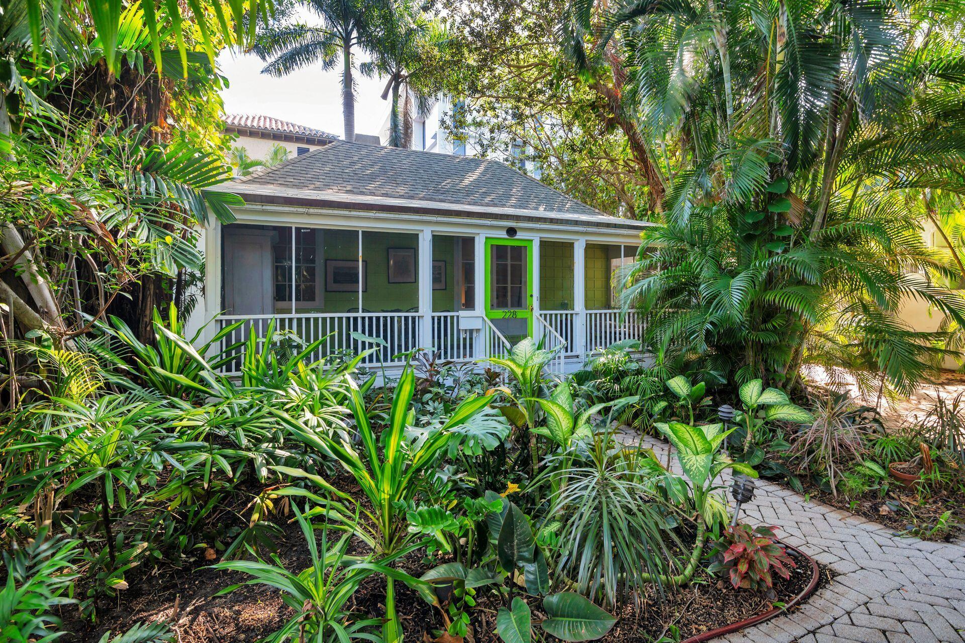 Walk back through time as you approach architect Howard Major's personal cottage nestled in historic Phipps Plaza, one block from the Ocean in midtown Palm Beach. Built in 1941 by the renowned architect and landmarked, the classic Florida-style cottage sits in a secluded setting in the Phipps Plaza cul-de-sac, surrounded by lush greenery. Included in the purchase is an adjoining landscaped lot which has the potential for a pool or water feature.