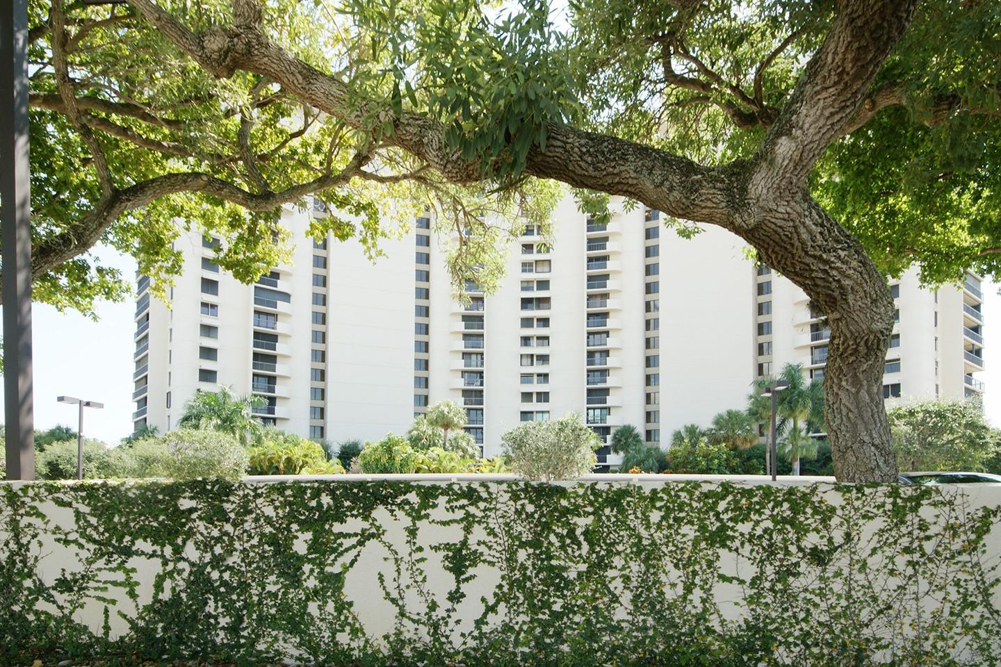 Enjoy peaceful serenity with views of majestic banyan trees through floor-to-ceiling windows and sliding glass doors in this prestigious Envoy apartment. This bright and beautifully updated 2BR/2BA residence features a spacious balcony overlooking lush greenery in the luxury high-rise with full amenities and a 24-hour doorman. Move-in ready, the home offers 2000 sq. ft. of living space, balcony included, an open kitchen with granite countertops, stainless steel appliances, custom cabinetry, and elegant lighting throughout. Additional highlights include, storm shutters, an in-unit laundry room with washer and dryer, an upgraded kitchen and upgraded bath rooms, tiles throughout, and an assigned covered parking.