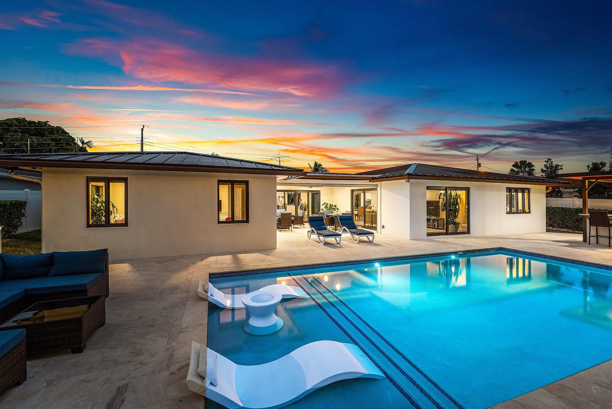 Welcome to your private slice of paradise in Lake Worth, Florida.  This 3 bedroom 2 bath home is perfectly situated on a peaceful canal on Lake Osborne.  The home has been completely redone from top to bottom within the last four years offering complete comfort, waterfront living and resort-style relaxation.  Enjoy 100% new everything from a new seawall, boat lift, jet ski docs, saltwater heated pool, roof, plumbing, electrical system, impact hurricane windows, A/C and septic tank.  All new within the last 4 years and meticulously updated for worry free living.  The home's outdoor spaces are an entertainer's dream, featuring a covered outdoor kitchen with bar, ideal for outdoor dining and gatherings All the household furnishings are also available for an additional cost.