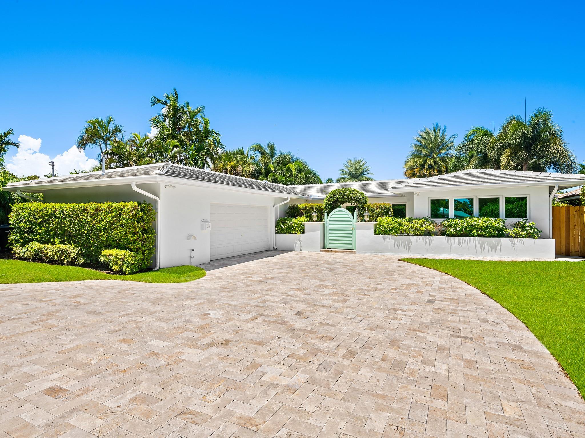 Picture living in Harbor Inlet, steps to a pristine beach, in this beautifully updated, tastefully elegant, 3/2 waterfront home. Step into the sun filled, open living area, where the ambiance evokes the calm of a private spa retreat, looking out to reveal a beautifully landscaped backyard oasis, featuring a new dock, soothing jacuzzi, and a sophisticated covered porch with retractable screens. Every detail throughout the home reflects thoughtful craftsmanship & refined taste. Curb appeal is simply unmatched, with a newly installed grand circular driveway offering ample parking for guests, two-car garage, setting the home back from the street behind an elegant gate, ensuring privacy and a stately presence. Enjoy direct ocean access with 80 feet of waterfront and only one fixed bridge.