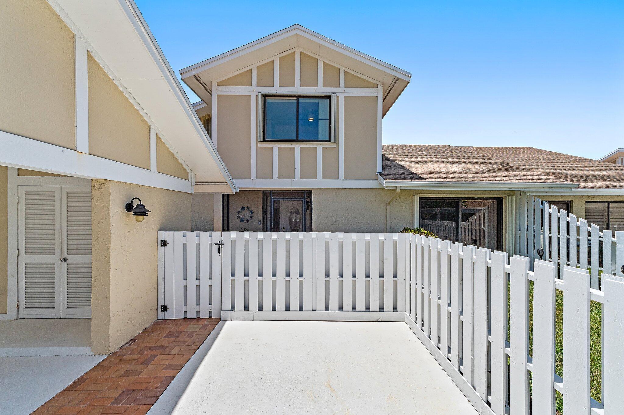 Located in the gated golf community of Jonathan's Landing, this 3 bedroom, with den, townhome offers a rare blend of privacy, functionality, and low-maintenance living just minutes from Jupiter's beaches. With two private outdoor spaces and a layout built for everyday comfort, this home delivers timeless appeal in one of Palm Beach County's most desirable neighborhoods.Inside, the layout flows easily from an inviting kitchen to a spacious living area filled with natural light. The primary suite is tucked privately downstairs, featuring a spacious bath, while two additional bedrooms upstairs offer flexibility for guests, remote work, or seasonal visits. A front courtyard and rear yard create options for indoor-outdoor living rarely found in attached homes.Cape Pointe residents enjoy
