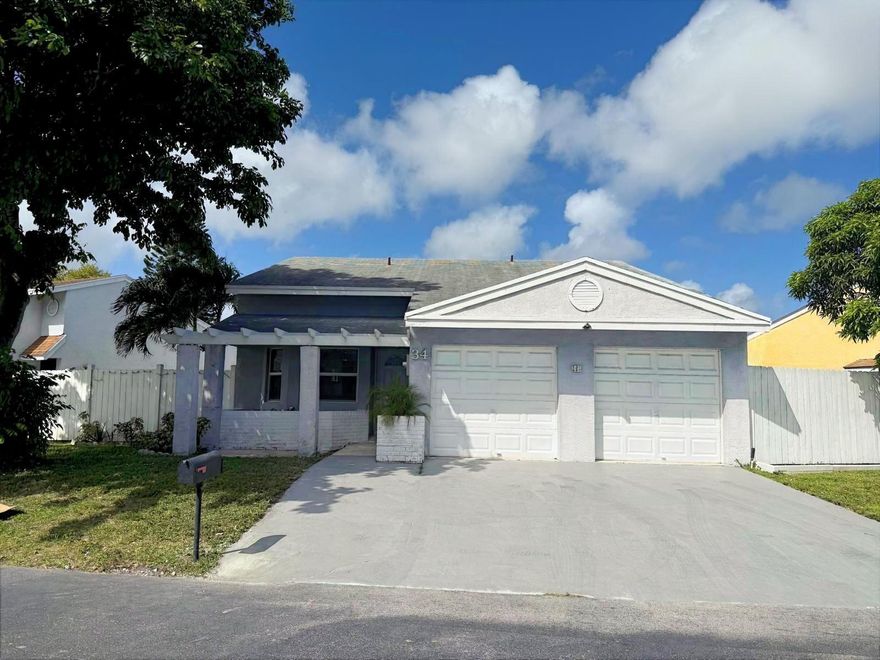 Highly desirable community in Boynton Beach! This amazing 4BR/2BTH home boasts magnificent lake views from all angles from inside the home, giving a serene and tranquil atmosphere to enjoy. The home has been updated, freshly painted, offering a modern open concept kitchen with quartz island, new appliances. The spacious interior features all-tile flooring throughout, and high vaulted ceilings. This property offers access to the community pool, which is the perfect place to relax and soak up the Florida sun. Note: the 4th bedroom is the garage that has been converted!
