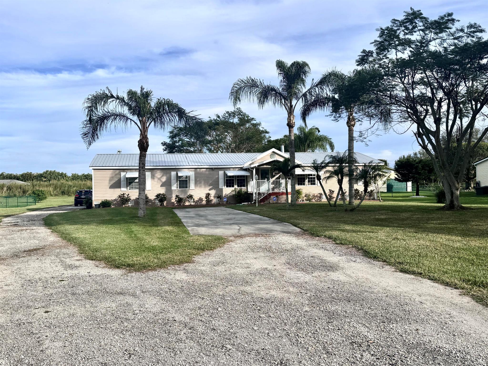 MOTIVATED SELLER. Discover the charm of this spacious 4-bedroom 2- bath home w/ 2278 ft. living space. Recent upgrades include newer metal roof & new AC w/ transferable warranty. The large carport, fenced yard & 2 storage sheds add to the properties convenience. Covered carport for RV included. Complete with shutters for all windows & back porch, this home is well prepared for any weather. Inside, the split Floor plan features a large master suite with walk-in closet & spacious bath, plus walk-in closets in all bedrooms & 2 large living room rooms-one with a cozy fireplace, & a bright kitchen with a large pantry. Sitting on 1 acre of land of this property offers plenty of outdoor space for relaxing & entertaining. Seller offering $5,000 towards buyers closing costs!