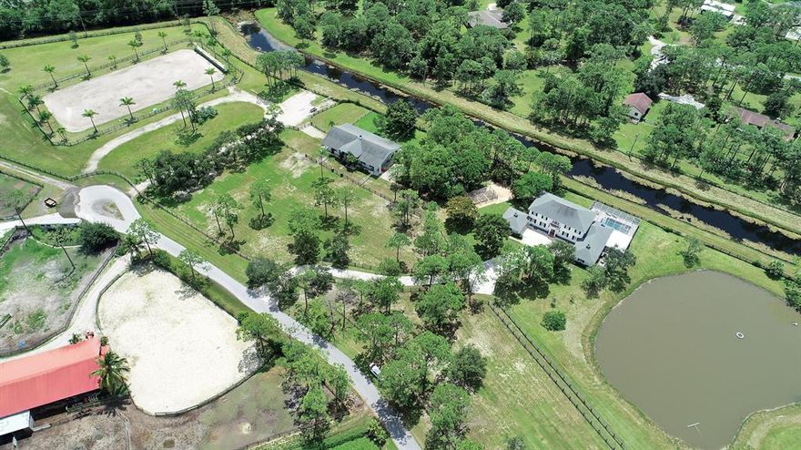 All Sizes Approx. Custom Built Ten Acre Equestrian Estate That Will Excite The Horse Enthusiasts! All The Hard Work Has Been Done For You! Large CBS Center Isle 4 Stall Barn That Could Have At Least 2 More Stalls. Two Wash Racks , Hot And Cold Water, Full Bath With Shower. Custom Stall Doors Are Just The Start To The Detail Of Attention This Barn Offers!  Professional , Irrigation, Landscape And Premium Fencing.  And An Almost  New Heated Pool! Recently Painted Plus The Recent Upgrades Make This Property Move In Ready! Four Car Attached Garage Plus Another Area That Could Be Additional Two Car Garage. State Of The Art Dressage Arena Gym Equipment Does Not Convey The wonderful community of Caloosa is an equestrian community that consists of 350 five acre home sites in Palm Beach Gardens. Fifteen minutes to Fla. Turnpike, 95 and the Gardens mall. Twenty five minutes to downtown West Palm Beach & Palm Beach International Airport. Caloosa's 32 acre horse park makes this neighborhood a real estate gem in Palm Beach County with over 30 miles of interior horse trails. Caloosa's community amenities include: dressage arena, a riding arena, jump course and a cross country area. Multiple tennis courts, children's playground, basketball courts and a barbecue area, community meeting room and restrooms. The private park is for the exclusive use of Caloosa residents and their guests. Caloosa residents enjoy events such as movie nights, chili cook offs, barbecues, holiday parades, benefit rides, demonstrations, and horse shows.