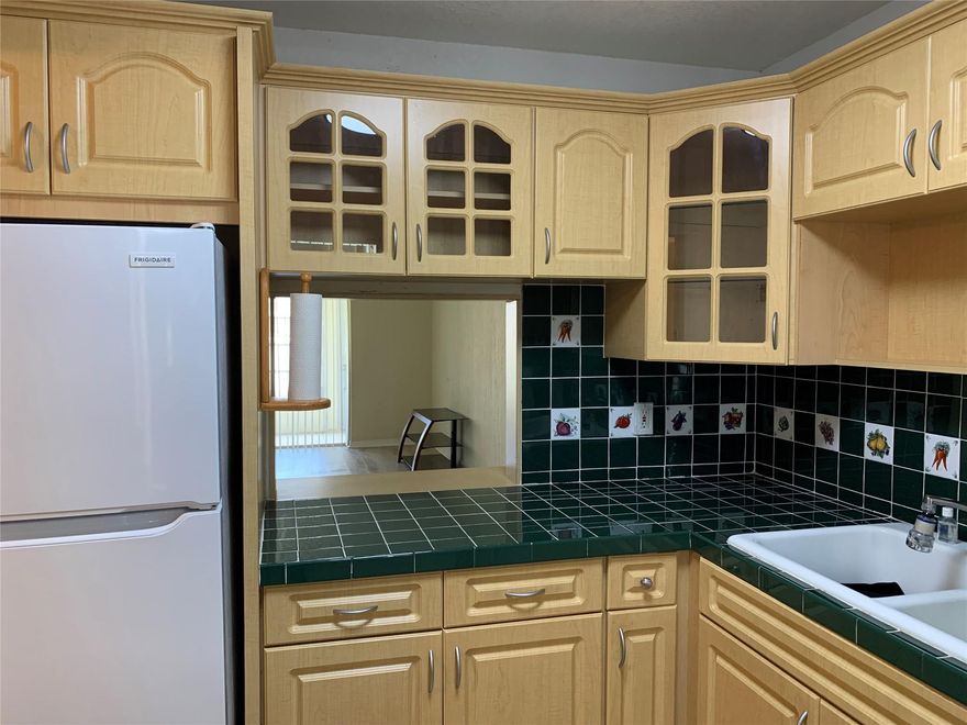REDUCED!  Rarely available GROUND FLOOR CORNER UNIT with laminate floors throughout and convenient parking directly in front including a custom ramp leading to your private entry.  Screened patio with easy access to the outdoors.  Bright and cheerful condo offers NUMEROUS UPDATES and thoughtful features designed to enhance comfort and convenience, including bathroom modifications that support easier daily living.  The layout is open and welcoming, with plenty of natural light throughout.  This residence combines style and practicality in a highly desirable location.  Community rules allow no pets; however, service and emotional support animals are welcome in accordance with the law.  Great clubhouse with lots of amenities and activities.