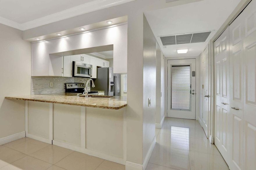 Beautifully updated 1BR / 1.5BA condo in desirable Wynmoor Village, Coconut Creek. This move-in ready residence features 24x24 porcelain tile flooring, elegant crown molding, smooth flat ceilings and walls (no popcorn), and an enclosed balcony overlooking peaceful garden views. The bright and spacious layout offers tasteful upgrades throughout and a comfortable living space perfect for relaxing or entertaining. Enjoy resort-style living with Wynmoor's exceptional amenities including golf, clubhouse, fitness center, pools, tennis, pickleball, theater, social clubs, courtesy transportation, and 24-hour gated security, all conveniently located near shopping, dining, and major highways.