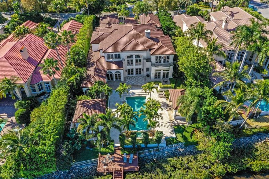 When you think of Admirals Cove in Jupiter, Florida, you visualize emerald fairways, pristine navigable waterways, luxury homes & amenities and a social life that will never leave you wanting for more. You can live this lifestyle here at 387 Eagle Drive. From the moment you drive through the Chicago Brick motor court, you'll realize you've found something unlike other properties in this price range. As you walk up to the giant red mahogany front doors and listen to the tranquil sounds of water cascading down the serene water fountain, you'll realize you've found your next place to call home. This concrete block home features impact windows and doors, concrete second floor, lush tropical landscaping, pool & spa and a dock that includes a boat lift and room for up to a 90ft yacht. Inside you will be overwhelmed by the large open spaces, the quality fit & finish and size of both the master and guest suites. Interior finishes include Level 5 Venetian Plaster walls, smooth texture ceilings, custom millwork package, Saturnia marble, hardwood and marble flooring, cast stone gas fireplaces and a new gourmet kitchen fit for a culinary chef including new custom cabinetry, Sub Zero & Wolf appliances and exotic granite countertops.

The back yard is where the magic happens. Sit at one of two covered areas, both with stainless grilling stations and both overlooking the pristine Admirals Cove waterways. This custom home may be one of the best waterfront estate home value in Admirals Cove.