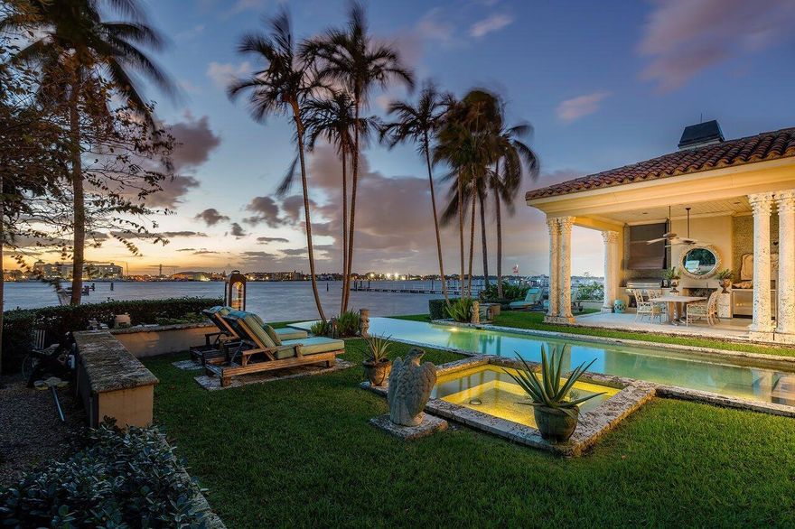 Welcome to **Palm Beach Panache**, a breathtaking masterpiece designed by the world-renowned interior designer Barry Dixon. More than just a luxury home, this two-story Mediterranean residence on Hypoluxo Island is a piece of art and truly only one of a kind. Every detail has been meticulously crafted to offer an unparalleled lifestyle, blending timeless elegance with modern refinement.This stunning direct Intracoastal property is a captivating fusion of Caribbean influences and the eccentric, theatrical style of 1940s English designer Oliver Messel. The result is a seamless, sophisticated home where architectural brilliance meets luxurious living.Step inside to discover a sanctuary of comfort and style. The interior boasts poured terrazzo floors throughout, evoking