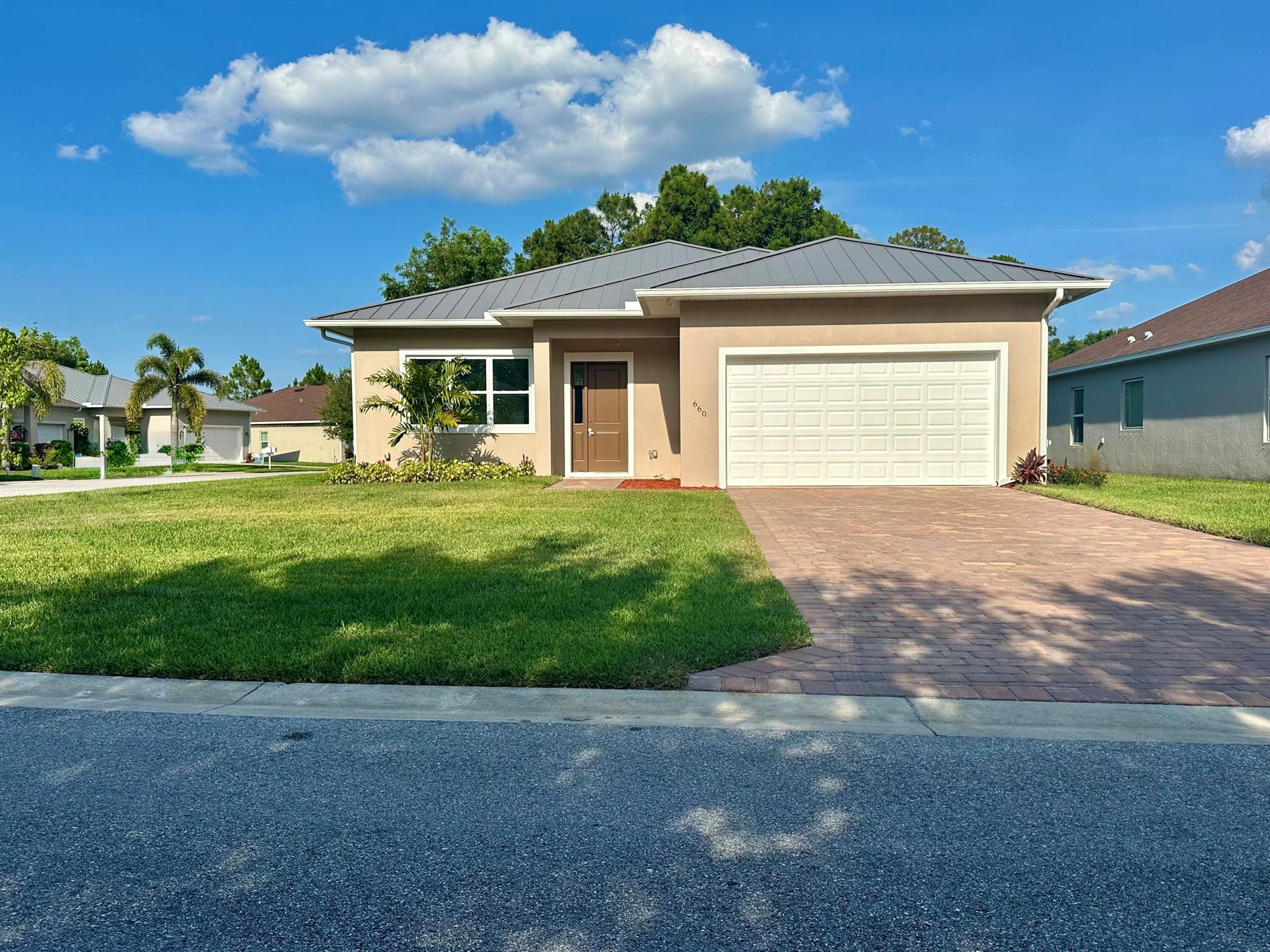 Discover modern elegance in this custom-built 3-bed, 2.5-bath detached home. The bright, open-floor plan boasts ceramic flooring, 11' high ceilings, and 8' doors. Standing seam custom color-matched metal roof, with impact windows and doors throughout. The chef's kitchen features stainless steel appliances, 36'' custom cabinets, and exquisite quartz countertops. Corner lot with sprinkler systems installed in front and back yards, a perfect relaxation spot. Exclusive community amenities include a private boat ramp, scenic lake, clubhouse, pool, hot tub, fitness center, nature trails, and RV/boat storage. Experience serene living while staying connected to all your needs.