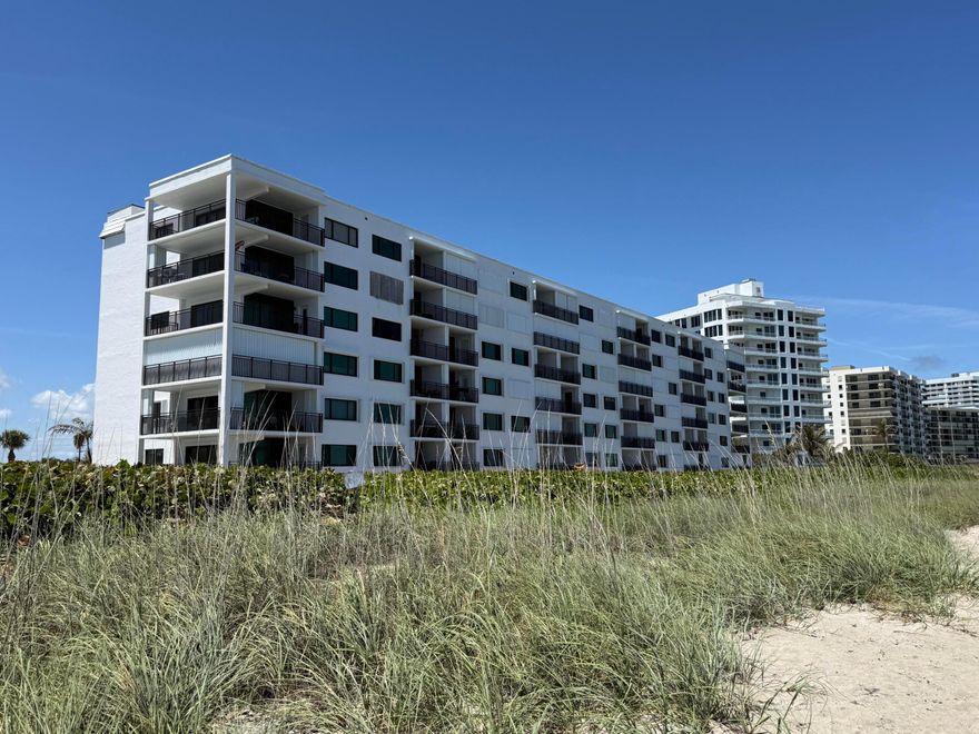 Highly desirable, SE exposure, oceanfront condo. Wake up to the sound of waves and endless ocean views in this stunning 2nd-floor beachfront corner residence—where luxury, privacy, and coastal living come together effortlessly. This 2-bedroom, 2-bath retreat is perfectly positioned to capture panoramic water views from nearly every angle, thanks to its coveted corner location. Step outside to your expansive wraparound balcony, an entertainer's dream and your personal front-row seat to sunrise mornings and ocean breezes. Inside, the home has been thoughtfully upgraded with impact glass throughout for peace of mind and energy efficiency, along with sleek luxury vinyl flooring that complements the light, airy coastal aesthetic.  The open layout invites natural light to pour in, creating a bright and welcoming space that feels like a permanent vacation. Beyond your front door, the community delivers a true resort-style experience: Sparkling pool just steps from the sand, Tennis and pickleball courts for active living, Convenient car wash station, Gated entry for added security and exclusivity. Adding even more value, the entire building has just undergone a full renovation, including new catwalks, balconies, roof, and elevators—giving you the confidence of modern updates without the hassle. Whether you're looking for a full-time residence, seasonal escape, or investment opportunity, this is coastal living at its finest—rare, refined, and ready to impress.