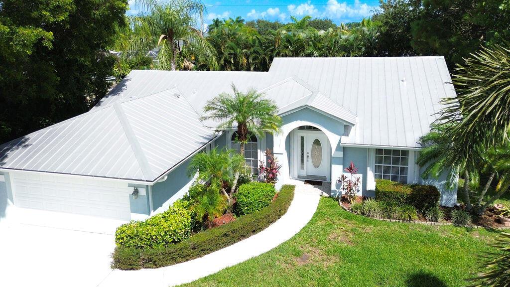 Tropical 3/2/2 Pool Home in Prime Location. Discover this beautifully maintained home in a highly desirable neighborhood. This inviting home offers the perfect blend of comfort and style featuring a split floorplan, metal roof and so much more. Step into your private backyard oasis featuring a sparkling pool and a custom Tiki Bar. Enjoy sunny days lounging by the sparkling pool or entertaining friends and family under the custom tiki bar - your backyard is made for making memories. Whether you're hosting a barbecue, sipping cocktails, or relaxing after a long day, this outdoor space is truly one of a kind. This perfect location is just a few minutes away from an ocean access boat ramp. A quick drive to the most beautiful beaches and minutes from shopping, dining and interstate.