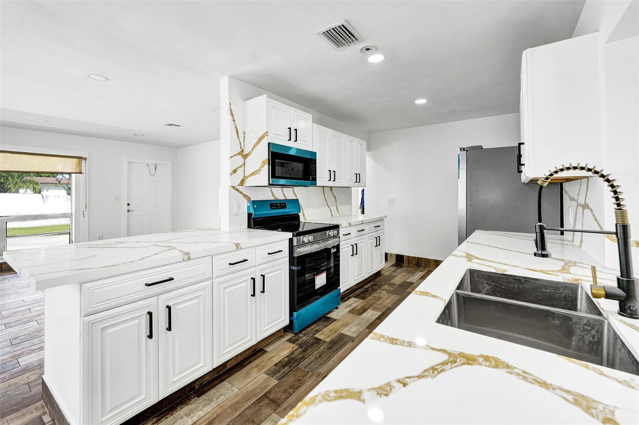 Step into this fully remodeled 4-bed, 3-bath Hollywood gem with an attached EFFICIENCY - with Appliances-Full Bathroom - Private Yard, NEW MINI SPLIT, can serve as a private primary suite, home office, or rental income source. Enjoy peace of mind with FULL HURRICANE PROTECTION, a NEW ROOF, NEW APPLIANCES, NEW HOT WATER HEATER, NEW BATHROOMS, FRESHLY PAINTED inside/out. The stunning NEW Quartz Countertop kitchen flows into a large laundry room and pantry. Tile floors throughout with Vinyl in the primary bedroom add a modern touch. The fenced backyard is perfect for relaxing or entertaining. Circular Driveway fits 4+ cars. This turnkey home blends style, comfort, and location—just minutes from major highways, The Hard Rock, beaches, shopping, and dining! No HOA! (3/2 main-1/1 efficiency)