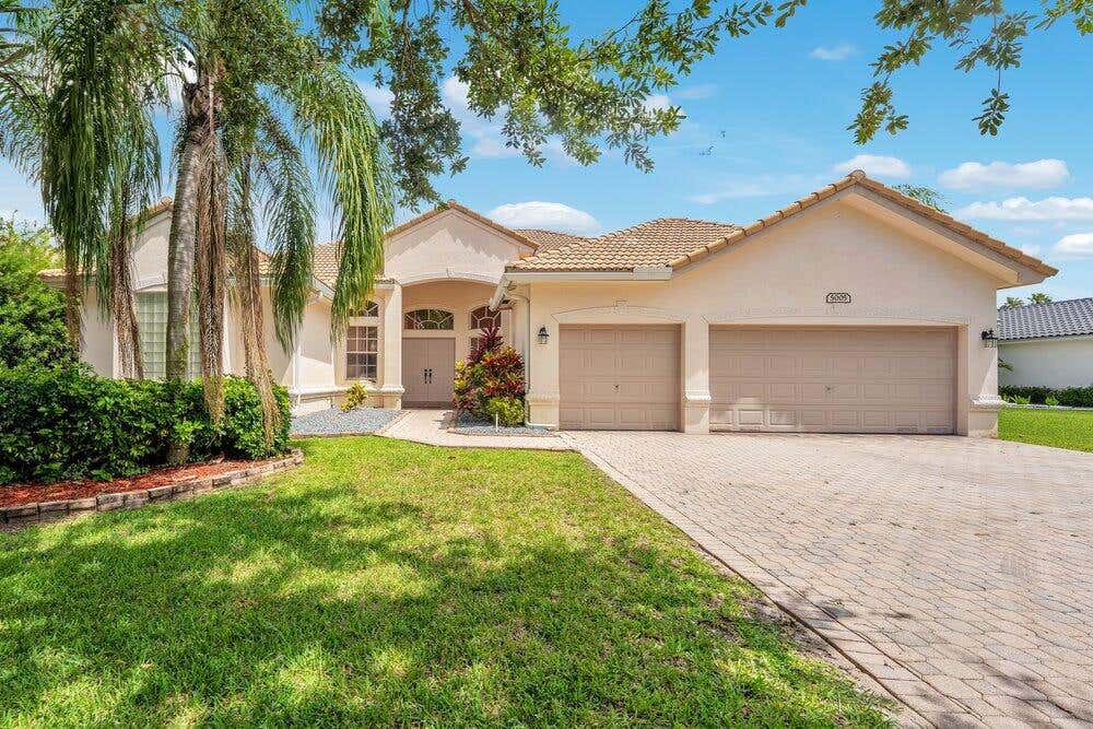 Photo of 5005 NW 57th Terrace, Coral Springs, FL 33067 (MLS # B26040046)