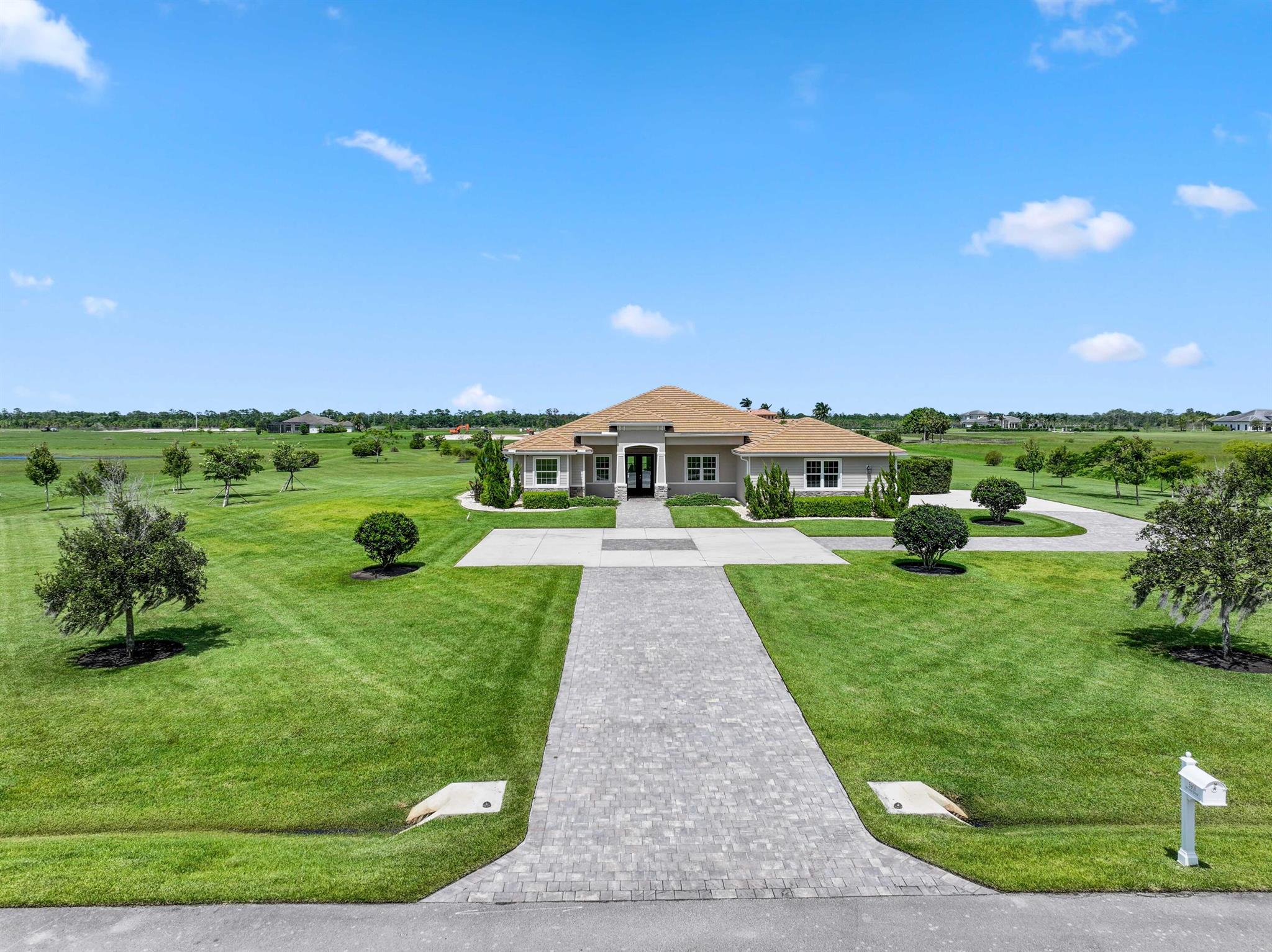 Welcome to estate living on 5 private acres in one of Martin County's most desirable neighborhoods. Built in 2019, this meticulously designed home has a flexible floor plan--currently featuring 3 bedrooms, an office, and a bonus room, with the option to easily create up to 5 bedrooms. The 3-way split design provides the perfect floor plan that is ideal for every buyer. You will experience the thoughtfully designed home from the moment you drive up. Enjoy volume ceilings and a great room with striking beams, plus a kitchen with a large island, pantry, and dining area perfect for entertaining. You will love your screened pool area overlooking the property. Energy-efficient features, impact glass, whole-house water filtration/generator, and extended 3-car garage. Equestrian friendly too.