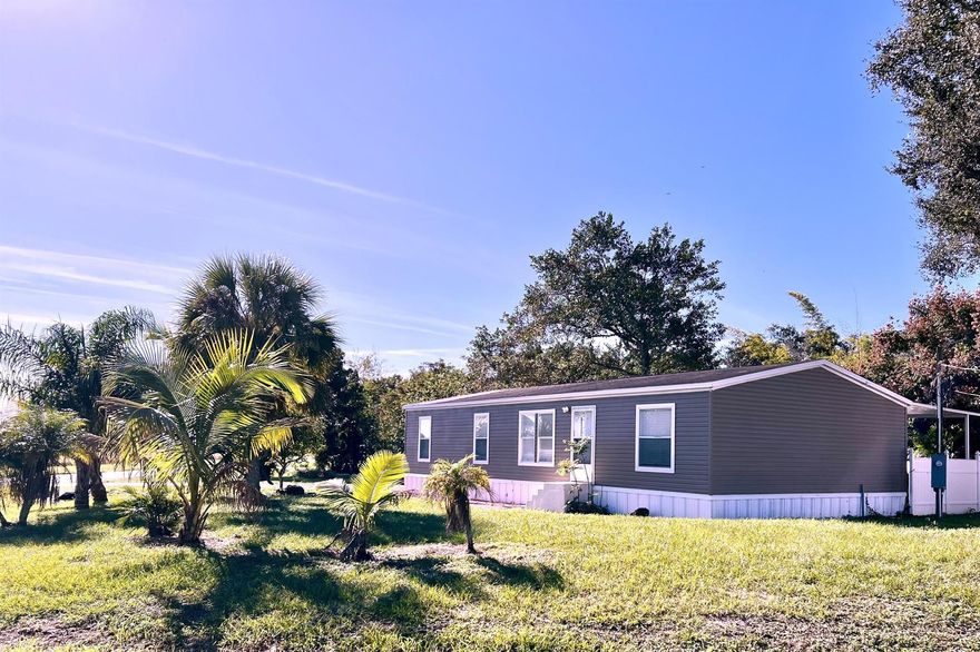 LAKE ''O'' Access ~ Waterfront plus country setting! 3Bd/ 2 Ba, 2015 DWMH. 12 x 27 covered deck  with beautiful water view and seawall. Concrete walkway to the water. 1411 Sf under air - 1735 TLA.  Spacious corner lot. Front porch faces pasture with Okee-Cows! New A/C, stove and refrigerator. New flooring and paint inside and out! Parking pad. Lovely palms decorate the front yard. MOVE RIGHT IN!Dimensions are approximate, must measure for exact