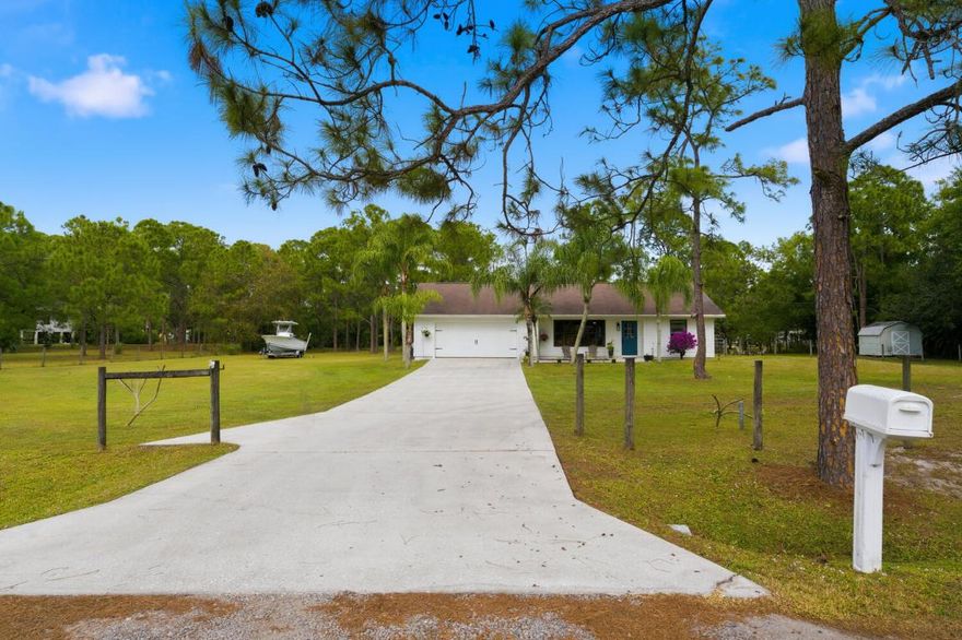 Charming 4 bed/2 bath single family home with 1,794 sq ft on approximately 1.25 acres of land in the highly sought after neighborhood of Jupiter Farms. Perfect blend of comfort and space! Open-concept living with a spacious kitchen, 4 bedrooms, primary suite w/ en-suite, and 2 full baths. 

Step outside to embrace the true highlight: 50,094 square feet of level, usable land with no HOA restrictions, perfect for privacy and endless possibilities. Plenty of room for all your toys—RVs, boats, ATVs, trailers, cars. Features an extended driveway. with open areas for extra storage or buildings. Ideal for workshops, gardens, hobby farming, or outdoor fun. Move-in ready with endless potential—your private retreat awaits!