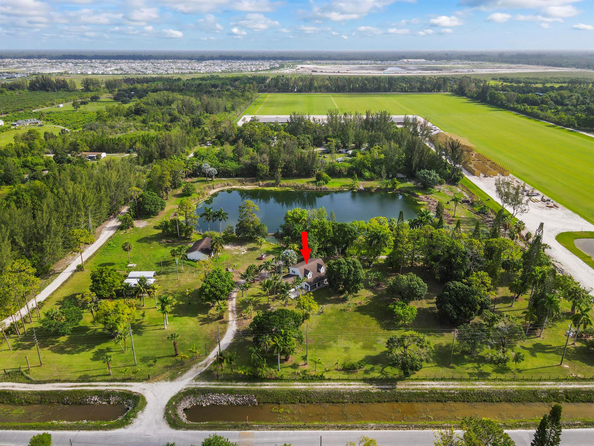 Potential Galore - 10 acre beautifully manicured property with a 1900 sq ft main home w/3 bedrooms, 2 baths, spacious loft, 2 car garage, PLUS a detached 1350 sq ft garage with mother in law suite including 1 bedroom, 1 bath, and kitchenette. One of the few homes on city water! 3 Covered RV sites with electric and a large pond that runs some of the irrigation sytem. AC works and roof is leak free! Backs up to the new Beldi Polo fields... location, location, location! Call to arrange your appointment to tour today!