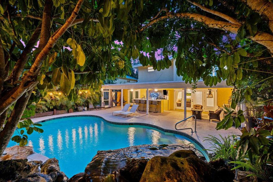 Villa Tranquila is an exceptional estate nestled on a park-like acre in the highly desirable Paddock Park community. Surrounded by lush Caribbean vegetation and accentuated by magical landscape lighting, this home exudes privacy and tranquility. Upon entering through the electric gates, visitors are greeted by a charming Spanish-tiled front walkway that sets the tone for the special features within. The main home boasts over 4,000 square feet of living space with 5 bedrooms and 4.5 bathrooms and features impact windows and doors. (2021)  A detached garage (2019) provides an additional 1,536 square feet (Valued at 250k and Sets Price Per Sq Ft at $415)At the heart of the home lies an incredible chef's kitchen, featuring a massive 9-foot island with seating and top-of-the-line
