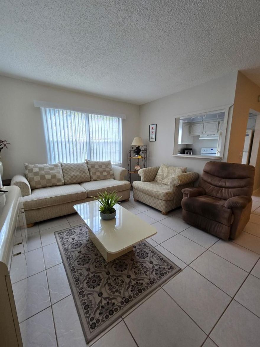 CORNER ,1/1.5 condo  on the second floor .  Very well maintained condo.  Neutral tile  floor throughout entire condo .  NEW AC  . NEWER Water Heater and El. Panel  .  Enclosed patio, where you can enjoy your morning coffee.    The main clubhouse has indoor and outdoor pool, restaurant, theater, clubs, classes, billiards, tennis, pickleball, volleyball, ping pong, shuffle board, fitness center, bike trails and more. Close to Beaches, Entertainment, Dining, Shopping.