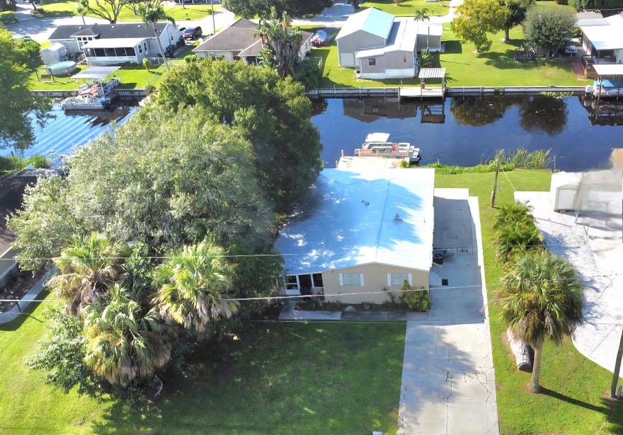 Welcome to your peaceful retreat on the water! Delightful 3-bedroom, 2.1-bath. Offers the perfect blend of comfort, convenience, and outdoor living. No HOA. Nestled along a serene canal with direct Lake Okeechobee access, this property is a dream come true for boating, fishing, and nature lovers. Features a durable 2022 Metal roof, spacious open-concept living areas. The formal dining flows into living spaces, making it ideal for entertaining or relaxing with family. The two main suites share a full bath, along with an additional half bath for added convenience, additional bedroom offer flexibility for guests. Step outside to your large screened-in porch and enjoy your morning coffee or evening sunset from the waterfront wood-dock. Turn key!