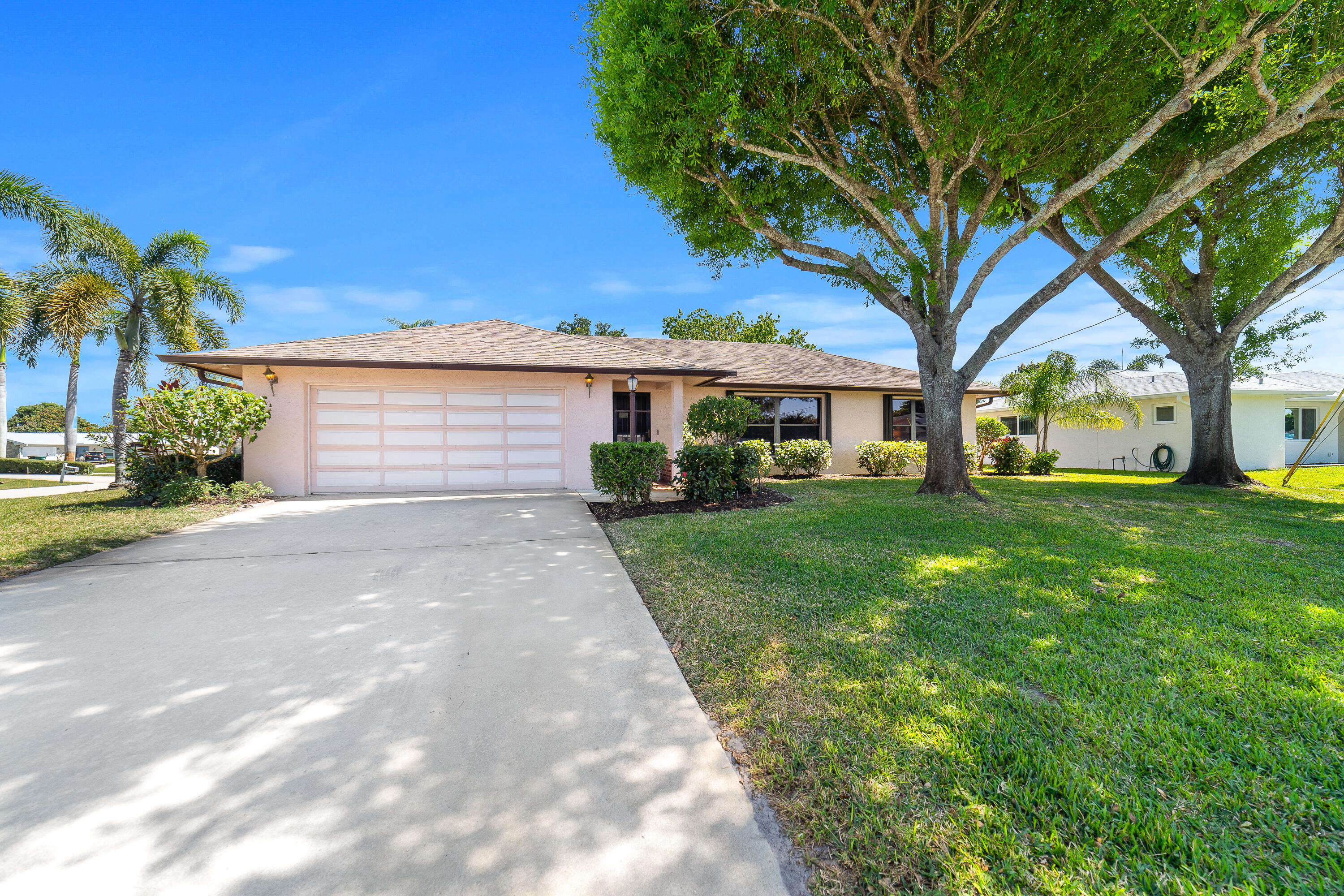 Discover the charm of this 1982 CBS home, nestled on a spacious corner lot in Port St. Lucie. Offering 1533 square feet of comfortable living space, this 2-bedroom, 2-bathroom residence boasts a desirable split-plan layout, providing privacy and convenience for all. The expansive backyard, presents a blank canvas for your outdoor dreams, with ample room for a pool and endless entertainment possibilities. The oversized back porch is a true highlight, featuring a pass-through window perfect for hosting gatherings and creating memorable moments. Enjoy the freedom of no HOA restrictions, while benefiting from the home's prime location, offering easy access to the Florida Turnpike and a wealth of nearby amenities. This quiet neighborhood provides a peaceful retreat,