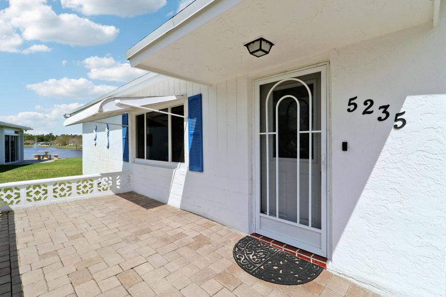 Welcome to one of the most unique waterfront homes in Cypress Lakes. This 2-bedroom, 2-bath, 1-car garage home is situated on a rare point cul-de-sac lot and sits on .25 of an acre, offering sweeping 180-degree lake views that can be enjoyed from nearly every room in the home- a beautifully positioned homesite that maximizes both privacy and scenery.  Whether relaxing in the living area or waking up in the primary suite, the tranquil water views create a peaceful, resort-like setting. Imagine living your best retirement life with resort-style living on your own peninsula. Can you see yourself sipping cocktails in the Florida Room while taking in the stunning lake views?  The home has been thoughtfully maintained with major updates already completed- including  a 2020 roof, 2022 HVAC, full impact windows and doors (with automatic roll-down shutters on the rear sliders), and gutters for added protection.  Located within the highly desirable 55+ gated golf community of Cypress Lakes, residents enjoy resort-style amenities including an 18-hole golf course (no membership required), a clubhouse, swimming pool, sauna, hot tub, two fitness rooms, tennis, pickleball, basketball, shuffleboard, a library, and a full calendar of social activities. The community also features a low HOA that includes cable, internet, and landscaping- providing both value and convenience while supporting an active and vibrant lifestyle.  This home truly checks all the boxes-  don't miss this opportunity. Schedule a showing today!