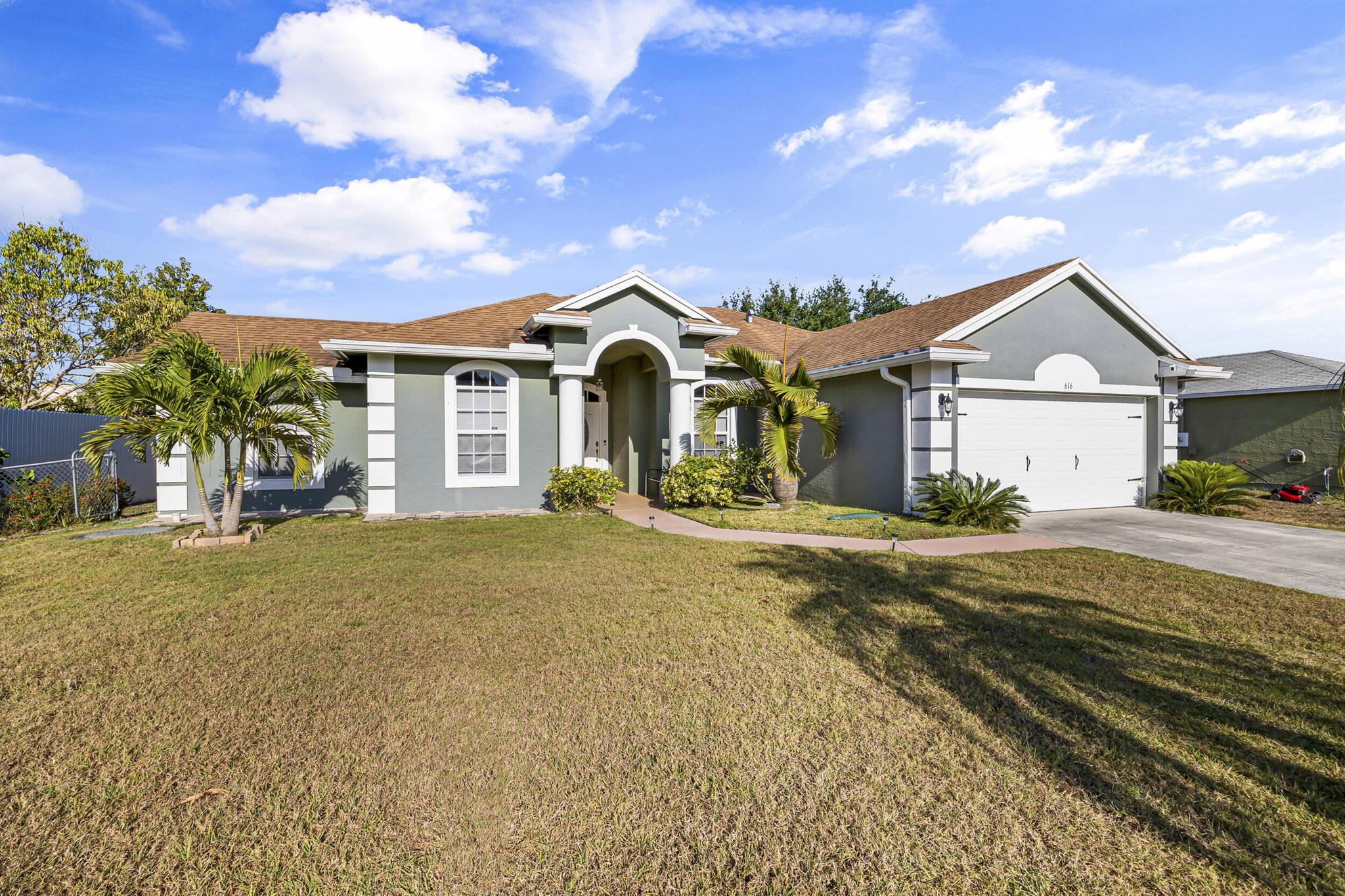 Beautiful newer CBS home Built 2010 located in the heart of Port St Lucie. It's been meticulously maintained and cared for. This 3 bedroom 2 bath home has an open floor plan with a split bedroom layout. You are not going to want to miss this one! Home features tile throughout, eat in kitchen, spacious bedrooms, primary bath has tub with separate shower and double vanity! Large guest cabana bathroom! Relax outside on your screen enclosed covered patio. Fenced in back yard with plenty of room for a large pool and has fruit trees! Great location, close to shopping, dining, I-95, hospital and more! No HOA!!!