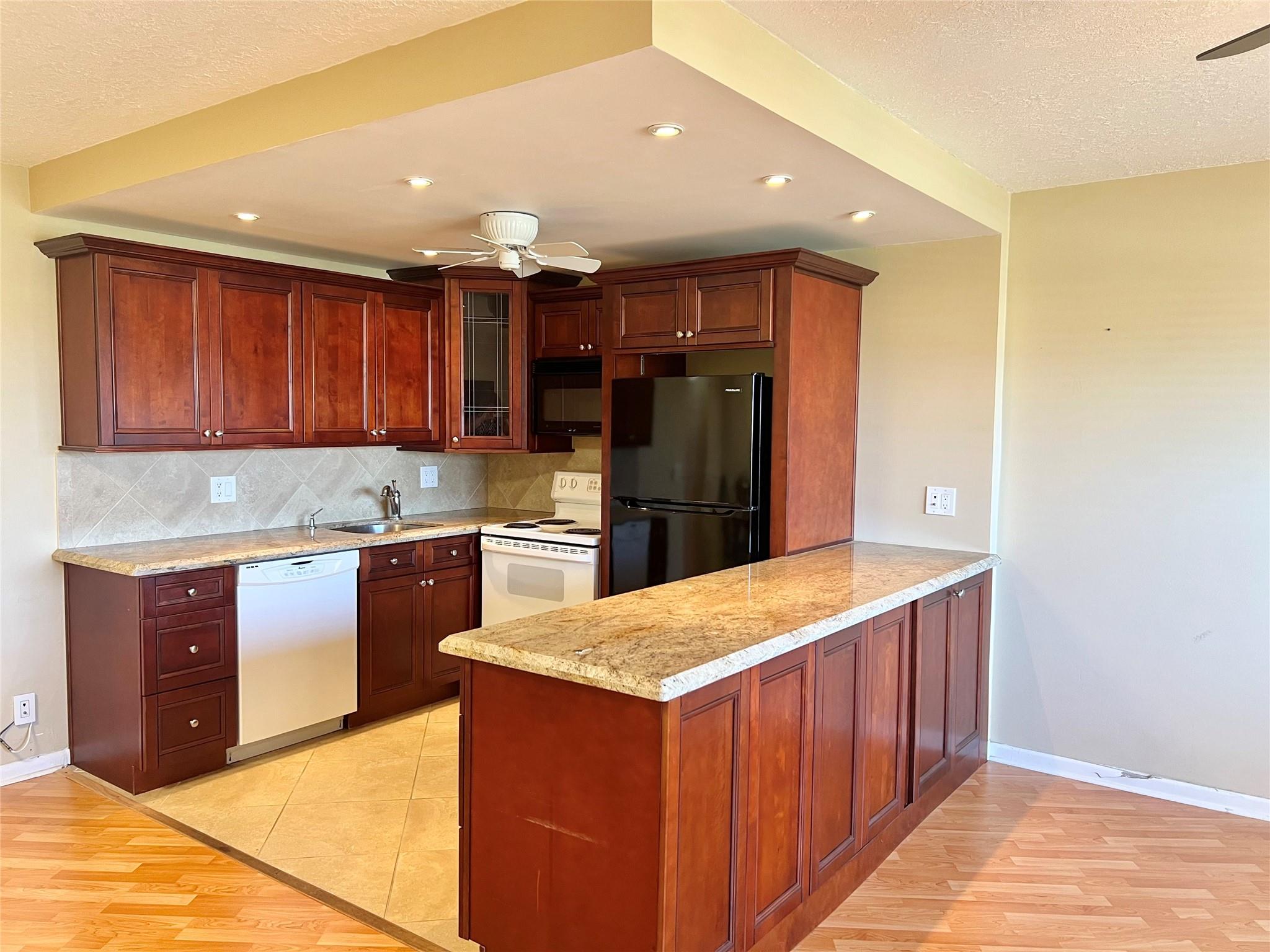 SELLER SAYS MAKE AN OFFER! YOU'RE GOING TO LOVE THIS ONE! BRAND NEW AIR CONDITIONING, HOT WATER HEATER AND ELECTRICAL PANEL! BEAUTIFUL OPEN KITCHEN FEATURING WOOD CABINETRY, GRANITE COUNTERTOPS, EXTENDED ISLAND, NEW CEILING FAN AND RECESSED LIGHTING. THE LARGE BACK PATIO HAS A EXPANSIVE GREEN SPACE VIEW TO ENJOY FROM YOUR TOP FLOOR HOME! CONDO IS LOCATED IN A COVETED AREA OF CENTURY VILLAGE. THE GRANTHAM POOL IS DIRECTLY ACROSS FROM THE BUILDING AND IN VIEW FROM YOUR FRONT DOOR. CENTURY VILLAGE HAS RESORT STYLE AMENITIES TO INCLUDE A CLUBHOUSE, INDOOR AND OUTDOOR POOLS, PICKLEBALL, TENNIS, THEATER WITH BROADWAY STYLE SHOWS, RESTAURANT, COURTESY SHUTTLE AND SO MUCH MORE! ASSOCIATION CLAIMS 55+