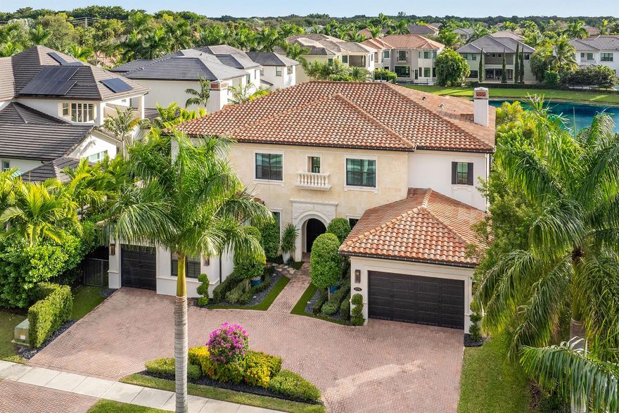 Located within the esteemed and family-friendly community of The Oaks in Boca Raton, this extraordinary lakefront estate is one of the largest and most recently completed homes in the neighborhood, boasting over 8,252 total SF of exquisite living space on an expansive 11,125 SF waterfront lot. With 6 bedrooms, 6 and 1/2 bathrooms, and an array of luxurious features, this home is perfectly suited for both grand entertaining and comfortable family living. The dramatic double-door entrance introduces a soaring foyer with a butterfly staircase, setting a refined tone for the home. The formal living and dining rooms offer an elegant space for gatherings, while the expansive open-concept kitchen is a chef's dream, equipped with top -of-the-line Wolf and SubZero appliances,