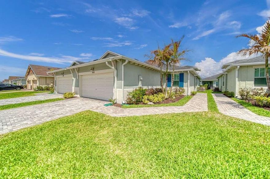 Welcome to this beautifully completed 2024 Lennar Azalea model offering 1,758 sq ft of thoughtfully designed living space with 3 bedrooms and 2 bathrooms, ideally positioned to capture peaceful lake views in a desirable Port St. Lucie location. This move-in ready home features upgraded waterproof luxury vinyl flooring throughout all living areas and bedrooms, delivering both durability and a clean, modern aesthetic. The open-concept kitchen is equipped with Corian countertops, ample cabinetry, and a functional layout ideal for both everyday living and entertaining.  Enjoy added peace of mind with impact glass windows throughout, along with tranquil water views that enhance the home's natural light and overall ambiance.  Additional upgrades include a garage with professionally finished  epoxy flooring, perfect for a polished look and easy maintenance. Step outside to a fully fenced and landscaped backyard, where you can relax or entertain while enjoying the serene lake setting.  Built in 2024, this home combines the benefits of new construction with immediate availability—no waiting, no construction delays. Conveniently located near shopping, dining, and major roadways, this property is an excellent opportunity to own a nearly new lakefront home in one of Port St. Lucie's fastest-growing areas.