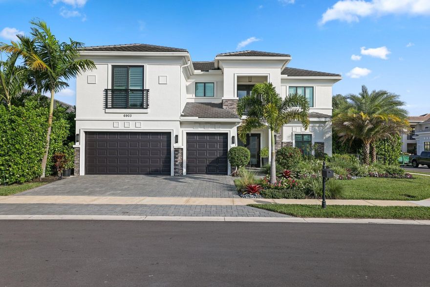 This Callahan model in Royal Palm Polo offers resort-style living on a corner lot w/ a side yard and lots of privacy. Featuring 5 spacious bedrooms, 5.1 bathrooms & office & loft. The grand entrance leads to soaring 23 ft ceilings & abundant natural light through large windows. The gourmet kitchen is equipped with Wolf & Sub-zero appliances, including a gas cooktop. The primary suite offers 2 primary bathrooms & walk-in closets & a serene covered patio overlooking the heated pool and private zen like yard. High end light fixtures & window treatments throughout. Located in the gated community of Royal Palm Polo in Boca Raton, this home is conveniently close to top schools and is a non membership community. Full House Generator & AC garage. See Video & Floor plan.