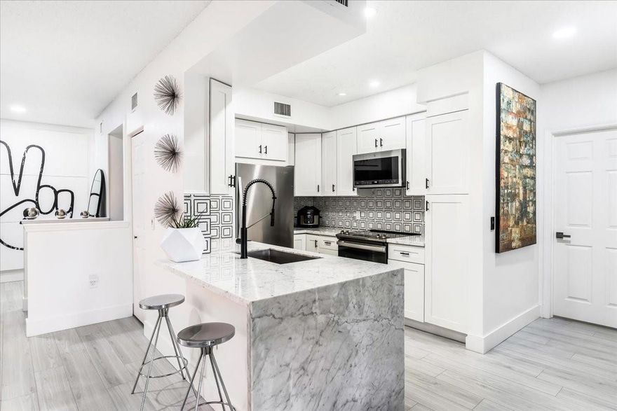 Modern and meticulous three bedroom two bath townhome with garage in Aventine at Miramar. Clean lines, designer finishes, and full of good vibes. Completely upgraded kitchen with white cabinets, stainless appliances, and waterfall countertop. Both bathrooms are redone and beautifully upgraded. Every space feels polished. The balcony brings true tree house tranquility with peaceful lake views. Resort style amenities including two pools, fitness center, tennis, playgrounds, jogging and biking trails, BBQ areas, and community parks. Prime Miramar location with quick access to major highways and minutes to top shopping and dining.