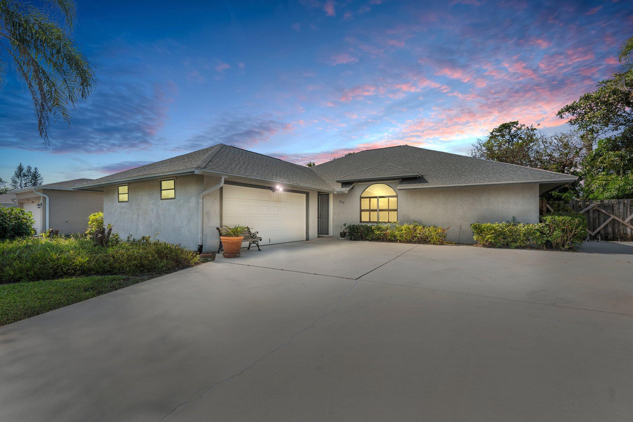 Location! Location! Welcoming you to Experience your own Florida Paradise, in this Custom-Built Pool Home! Step inside this Inviting, 3 Bedroom, 2.5 Bathroom, 2 Car Garage Home, with RV/Boat Pad, located in east Port Saint Lucie, tucked away in a quiet neighborhood, just minutes from Martin County! This Unique Pool Home has Natural Light beaming from every angle! Enjoy the Open and Spacious, split Floor Plan Layout, featuring Vaulted ceilings in the Main Living Areas, separate Formal Dining Room, and 2 Family Rooms.
