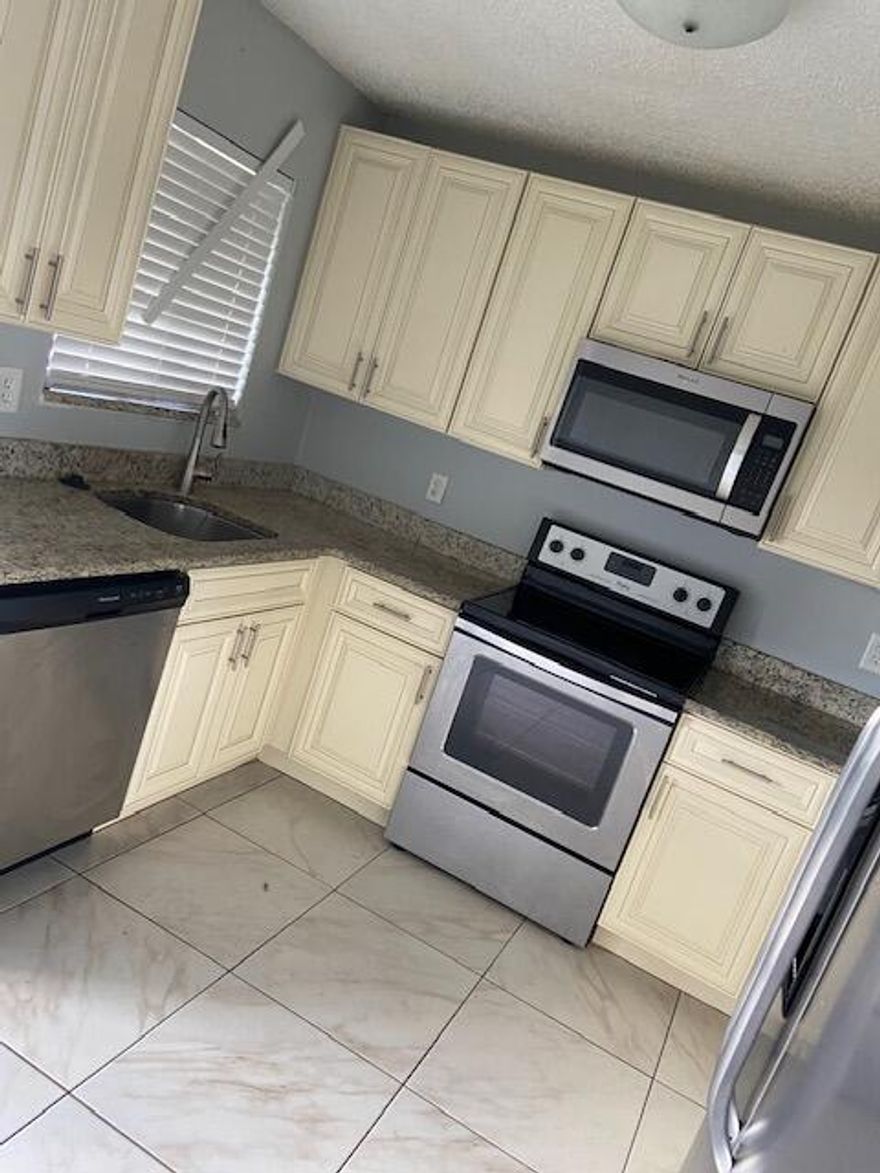 Beautifully renovated 3 bedroom, 2 bath villa (end unit) featuring a stunning new kitchen with white cabinets, granite countertops, and stainless steel appliances. Updated bathrooms include new tile, vanities, and fixtures. Luxury flooring throughout adds a modern touch. Enjoy peace of mind with a newer AC and 2018 roof. Relax on the screened patio with a convenient storage area. Some TLC needed!!