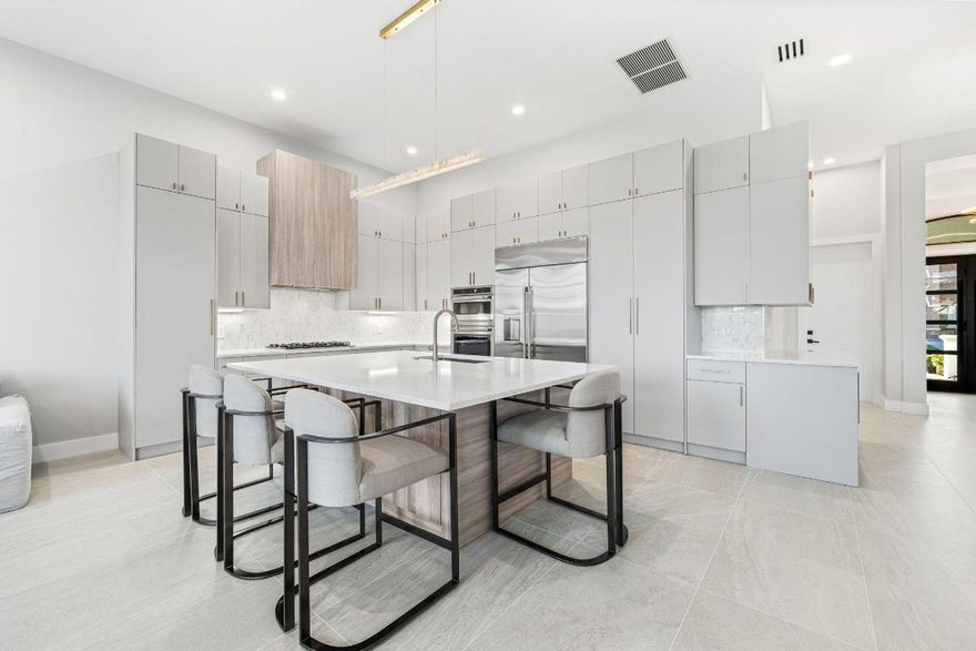 *2026 Renovation *Mirabella Community *Kenco Built *Modified Rossello Model *Lakefront 1 Story *12ft Ceilings *4 Bedrooms *3 Bathroom *New Kitchen with Euro Style Cabinets *GE Cafe Appliances (48 inch Fridge) *Large Island 64X90 *Custom Designed Hood *Natural Gas *New Bathrooms *New Fixtures * New Lighting *New Porcelain Tile 24x48 Floors *New Millwork/Baseboards *Custom Closet Built-Ins (Primary Suit) *Half New Impact Windows *Resurfaced Pool *New Pool Deck 24x36 porcelain tile * Refreshed Screened Lanai *Open Concept *Removed Dated Interior Archways *Smoothed All Knockdown Walls *New Flat Tile Roof(2025) *2024 ACs *2020 Water heater *Active Community *Fabulous Neighbors *Large Clubhouse with Fitness Room, Weight Room and Tennis Courts *Kids Club *A rated Schools *Close to I95 & Turnpike A stunning, exquisitely reimagined one-story lakefront residence showcasing a level of renovation and design not previously offered for sale in the Mirabella community. The home has been thoughtfully transformed with a new flat tile roof, soaring 12-foot ceilings, and a refined modern interior achieved through the removal of dated knockdown finishes and interior archways, resulting in clean lines and a contemporary aesthetic. The home features a bright, open living environment, with oversized 24x48 designer tile grounding the main living areas and enhancing the home's refined, modern aesthetic.

The chef's kitchen serves as a true focal point, featuring GE Café appliances, an impressive 48" refrigerator, a custom-designed statement hood, and sleek contemporary finishes designed for both entertaining and everyday living. Spa-inspired bathrooms provide a refined, resort-style experience with new plumbing fixtures, designer lighting, and calming, high-end materials.

Indoor and outdoor living blend effortlessly, opening to a newly resurfaced pool, updated pool deck, and refreshed screened-in lanai overlooking tranquil lake views. The well-planned single-story layout offers four bedrooms and three full bathrooms, delivering modern luxury, comfort, and elegance in a highly desirable lakefront setting.