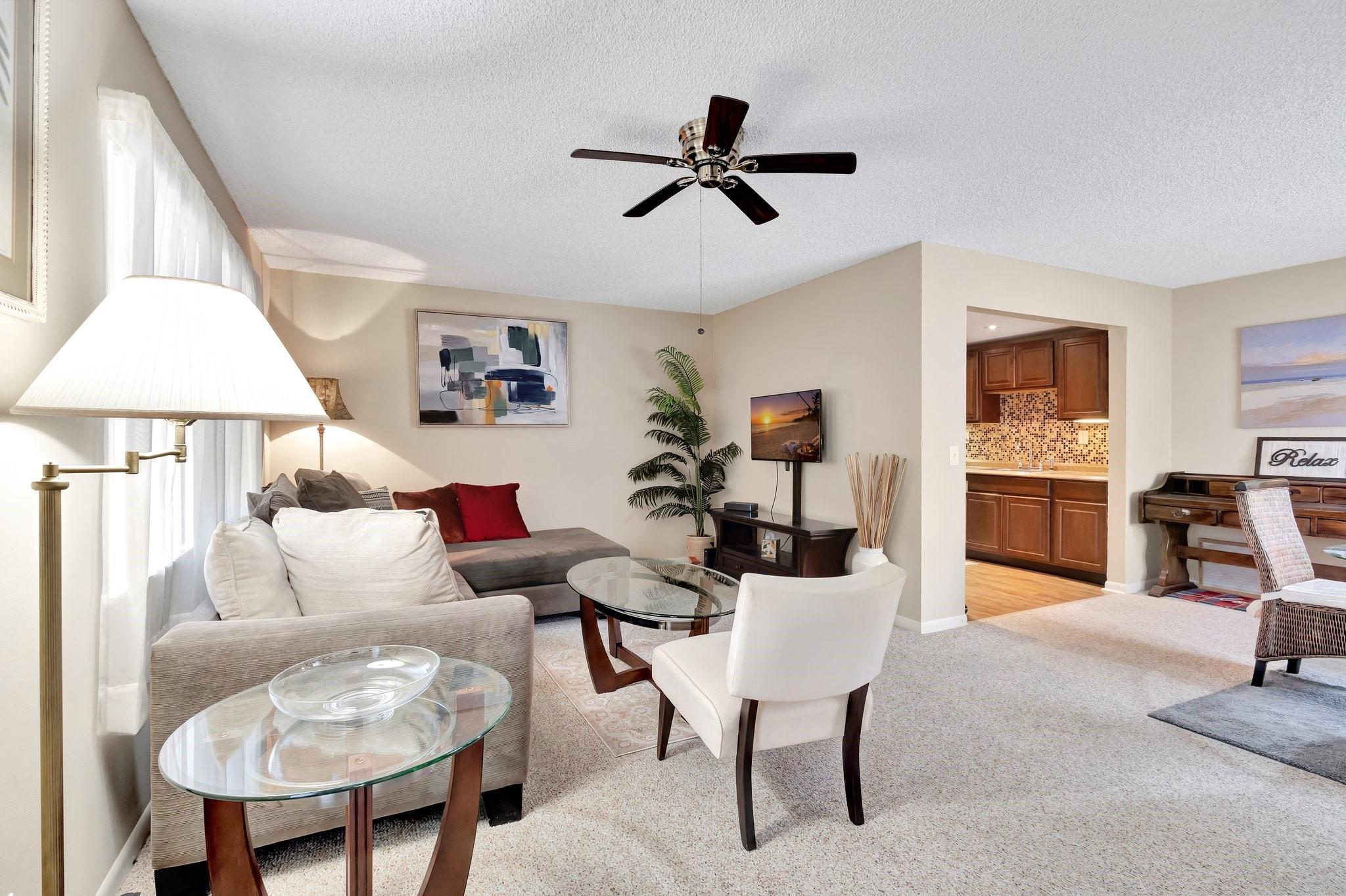 Live the dream in this bright, stylish home! The open layout flows from the chic living area to a gleaming kitchen with stainless appliances and mosaic backsplash. Enjoy meals in the sunny dining space or morning coffee on your private balcony with palm tree views. Your washer & dryer are located in your new condo!
The spacious bedroom offers generous closets, while updated baths add a modern touch. Step outside to indulge in multiple clubhouses, pools, spas, tennis, pickleball, golf, live shows, and more plus a courtesy bus for ultimate convenience. This is a gated 55+ community. Condo offered furnished as seen in the photos.