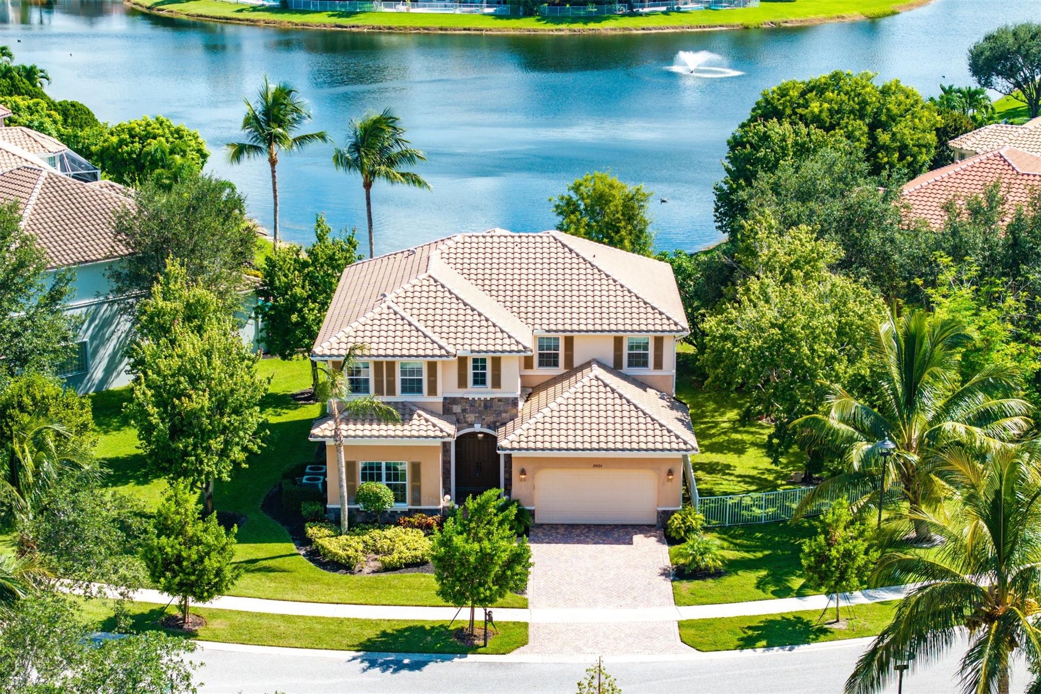 Stunning 5-bedroom, 4.5-bath lakefront home in a gated community with resort-style amenities. Enjoy wide water views and a light-filled layout featuring ceramic tile floors, knockdown ceilings, raised panel doors, and elegant Colonial trim. The gourmet kitchen offers European-style cabinetry, granite countertops, and stainless steel appliances. Upstairs, the spacious primary suite boasts a private lakefront balcony, custom closets, a sitting nook, and a spa-inspired bath with dual sinks, soaking tub, and separate shower. Generously sized bedrooms and open living areas make this home perfect for both everyday living and entertaining.
