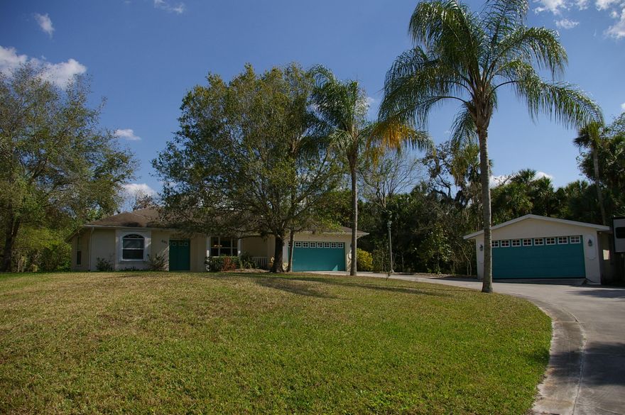 Come discover this 1.99 Acre tropical oasis. Home is a 2356 sq ft living area split plan home with screened in pool. The home is a 4/ 2.5/ 2 with additional detached 2 car garage & RV Parking.  Bonus garden shed for additional storage,Total home area is 4451sq ft.  Fabulous built-ins including His & Hers built out office, Murphy bed and custom wall unit. Leave the pool area and leave your worries behind as you walk down the over 800 ft boardwalk through the hammock to your piece of paradise. Boardwalk ties directly into boat dock and screened in sitting area. Launch your canoe or kayak from additional launch area. Thiis is a must see property!  Schedule your private showing today.