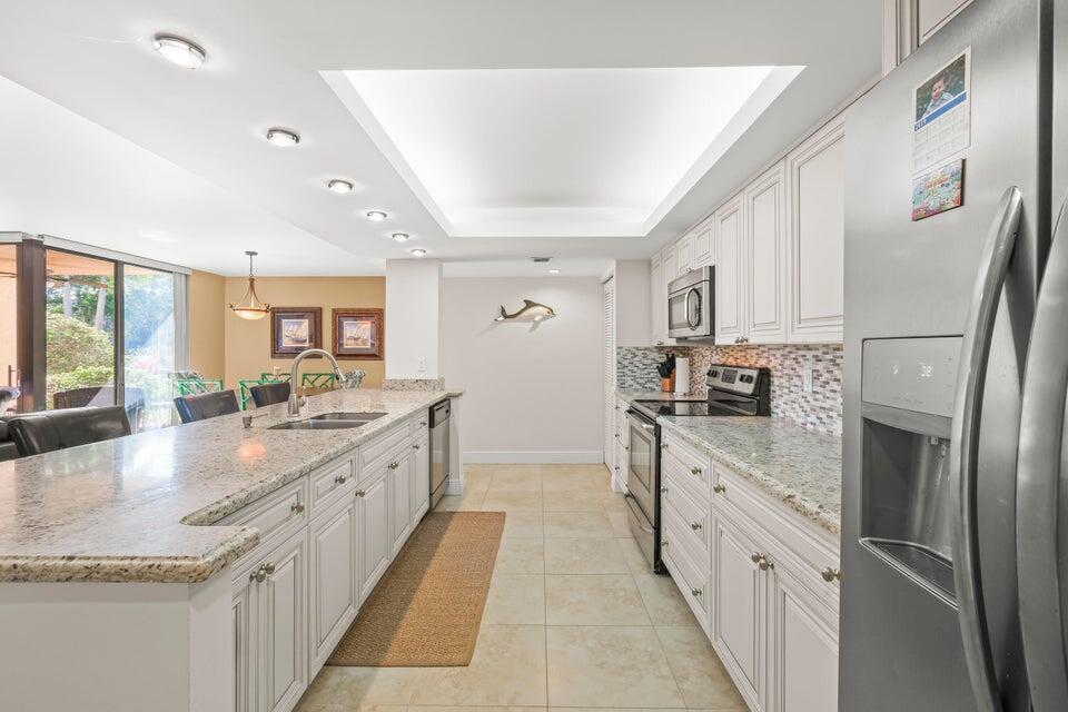 Welcome to this beautifully renovated 2-bedroom, 2-bath condo, designed with modern living in mind. Boasting an open-concept floor plan perfect for entertaining, the large kitchen island is the heart of the home. Experience the best of the Delray Beach lifestyle, just one mile from the vibrant downtown area. The spacious split floor plan ensures privacy and comfort, while the laundry room with a full-size washer and dryer adds convenience. Step out from your cozy lanai and enjoy seamless access to expansive outdoor spaces. The community offers resort-style amenities including two pools, a fully-equipped fitness center, and tennis courts. Just a short walk to shops, restaurants, Whole Foods, and Target, plus only 1m to the beach. Available fully furnished & turnkey for a seamless move in.