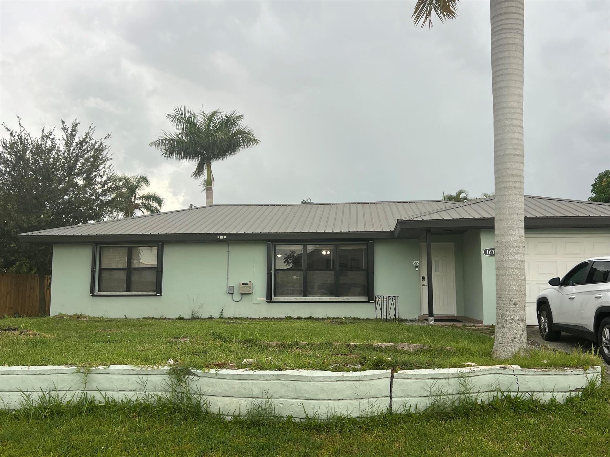 Check out this well kept 3/2/1 CBS home in Port St Lucie.  Kitchen has been updated with white cabinets and granite countertops.  This home offers tile throughout. Both bathrooms are also newly redone. Enjoy your own private covered patio with large backyard. Close to turnpike for commuters. Close to shopping and restaurants .Tenant responsible for lawn maintenance. Available December 15, 2025