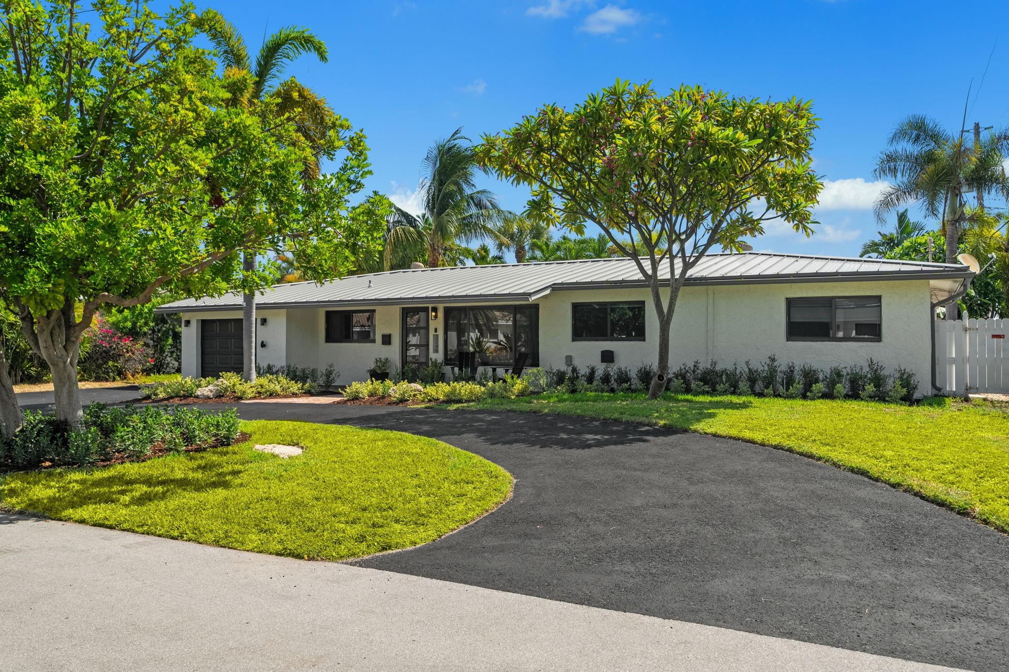 Prime Lighthouse Point Location near parks, boating, and dining! This updated 4BR/3BA home in sought-after Lake Placid is steps to Frank McDonough Park and the Lighthouse Point Tennis Center. The home features a newer standing seam metal roof (2018), impact glass windows & doors, almost all PVC plumbing, 2019 AC, new lifetime-warranty flooring and new pool heater. The interior is freshly painted with new light fixtures and the open living spaces are ideal for entertaining. The kitchen boasts newer appliances and brand new quartz countertops. Includes a 1-car garage and storage shed. This move-in-read home blends modern upgrades with Florida resort lifestyle living-Relax in your heated pool, tiki hut, and lush tropical landscaping.