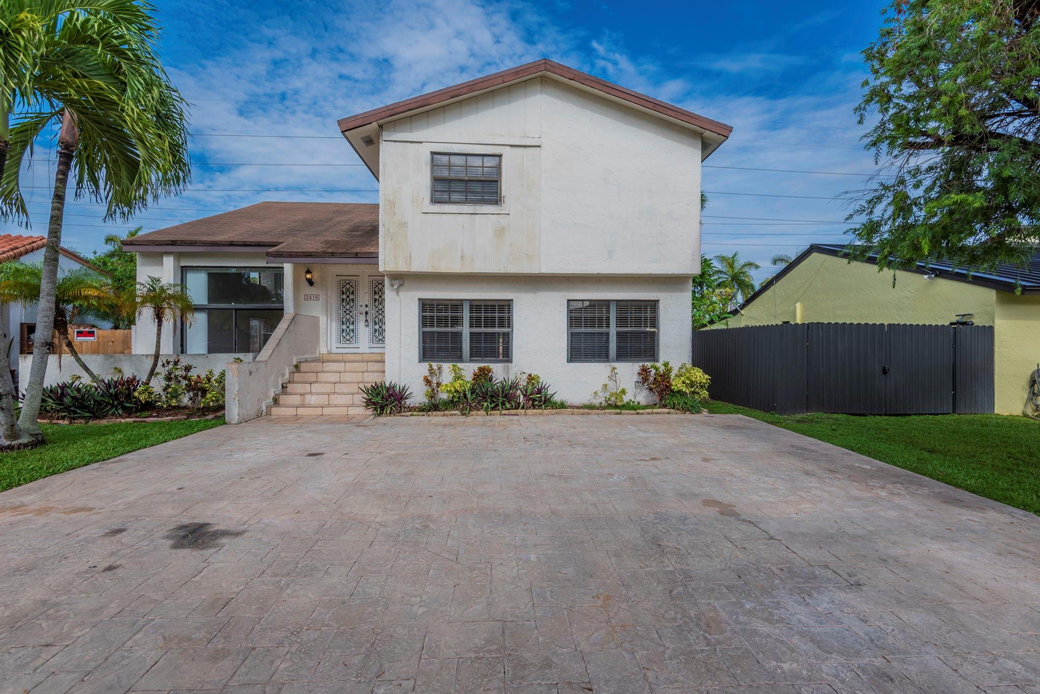 Flexible two-story layout with four bedrooms and three full baths, including a convenient first-floor bedroom/bath for guests or multigenerational needs. Living and dining areas flow to a bonus Florida room and a fenced backyard with a simple patio—great for everyday living or casual entertaining. Easy access to shopping, dining, and major routes in a central Miami location. Some photos have been virtually staged to show potential layout and design.