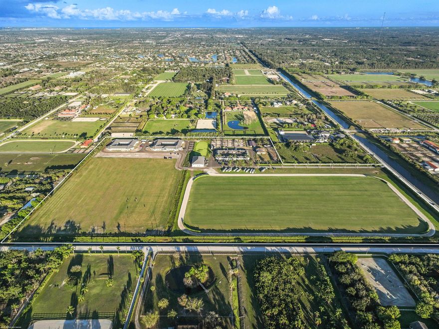 Reduced $7,500,000. One-of-a-kind opportunity to own a 46.96 acre equestrian facility in a prime Wellington location on a paved road and with no homeowner's association. The property boasts 4 stables, totaling175 stalls, full size polo field with exercise track, a second stick & ball practice field, maintenance garage and two staff houses. Two new show barns were built in 2024, one with 52 stalls & the other with 59, it also features a 2nd floor viewing room with balcony overlooking the polo fields. The original courtyard-barn holds 48 horses and the over flow barn has 16 stalls.  The staff houses each have 4BR & 4Bths.  The property is comprised of multiple parcels which could lend itself to future subdivision. This farm has unlimited potential for all equestrian disciplines. A must see!