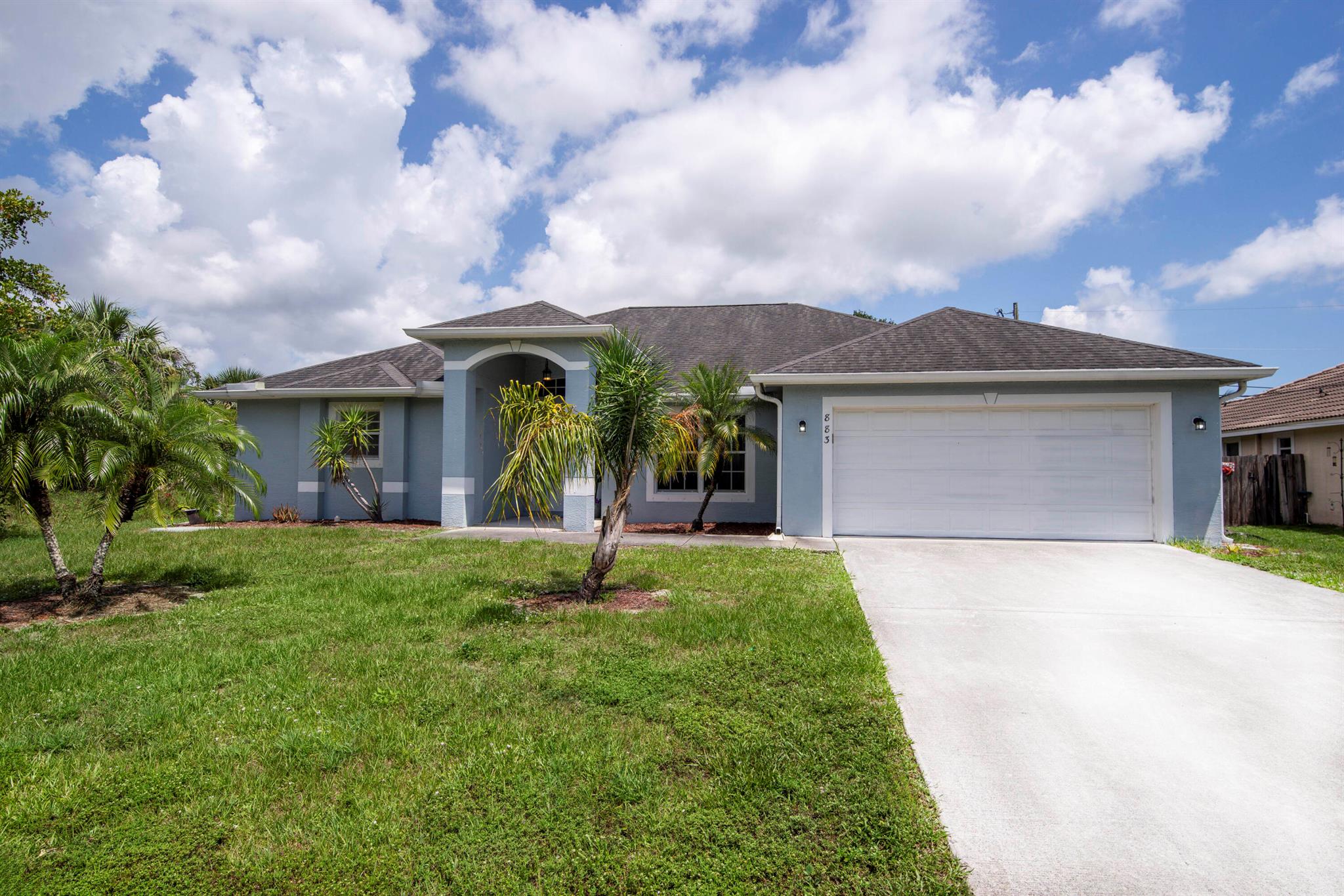 Welcome to this wonderful and spacious 4BR, 2BA and 2-car garage one story home located in the heart of Port St. Lucie. This beautiful home features a foyer which opens to your eat in kitchen with white wood cabinetry, white appliances, tile flooring, recessed lighting, high ceilings, a large breakfast bar, and an oversized pantry. The living room is light and bright with tile flooring, high ceilings, large windows, and decorative moldings. The dining room is adjacent to your living room which features tile flooring and glass sliding glass doors to your private screened in porch where you can entertain family and friends. The primary bedroom features tile flooring, decorative moldings, and glass sliding doors to your spacious screened in porch to enjoy your