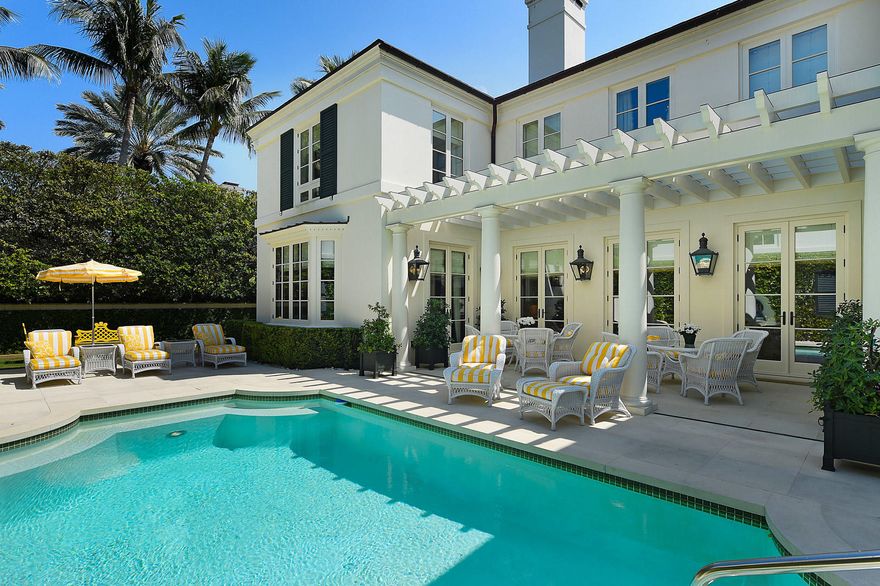 Spectacular 5BR/6.2BA home located in Palm Beach's acclaimed Estate Section, beautifully designed by award winning architect Mark P. Finlay. Features gorgeous antique limestone and antique hickory hand-scraped hardwood flooring, perfectly scaled rooms, and exceptional finishes throughout. Stunning paneled library with fireplace and full bath, first floor VIP guest suite, formal dining room, and first and second floor laundry rooms. Gourmet eat-in Chef's kitchen with Wolf and Subzero appliances leads to breakfast room and light-filled family room. Elegant formal living room with fireplace opens to pergola covered loggia and tranquil pool area. Additional highlights include soaring 10'+ ceilings on the first floor and 9' ceilings on the second, 1BR/1BA guest apartment, elevator, and full-house generator. Ample parking with circular drive and large driveway leading to 2 car garage.