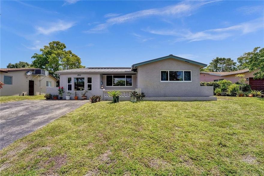 Great opportunity in Hollywood Hills! This 2 bedroom + den, 2 bath house has a newer metal roof (August 2021), impact windows and doors (2017), solar panels (2018) and a new AC (December 2022). The inside is waiting for you to customize and create your dream living space! Enjoy the peaceful backyard on your patio, with mango and banana trees, and room for a pool.
