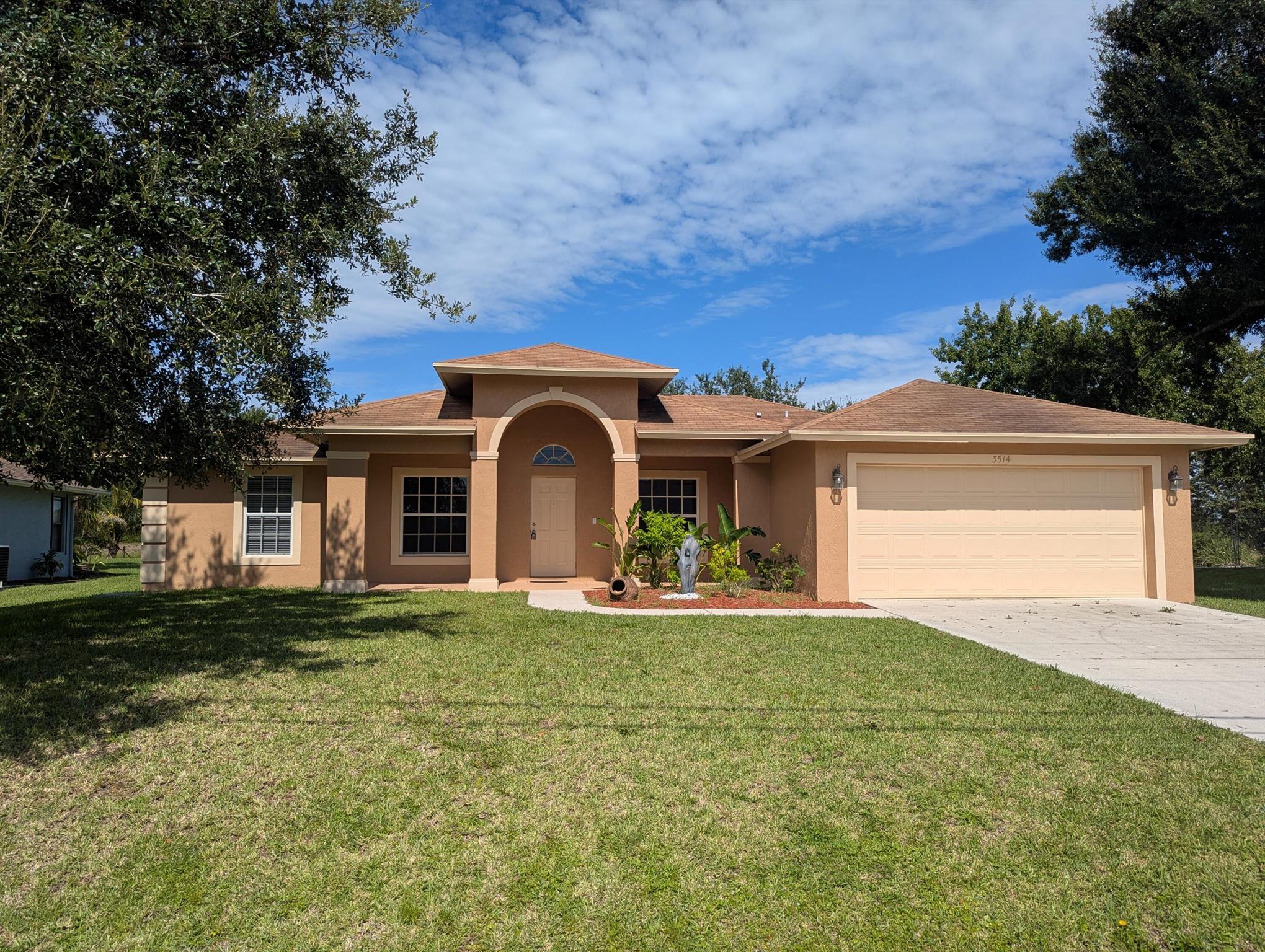 Available now! Live lakeside in this spacious 3 Bedroom , 2 bathroom Port St. Lucie home with bonus den/flex room --perfect for a home office, playroom, or guest space. Featuring tile flooring throughout, this freshly painted home offers easy maintenance and a modern look. Enjoy separate living and dining areas, plus a kitchen with stainless steel appliances, ample cabinetry, and great flow for everyday living. The primary suite includes a walk-in closet and private bath. Step outside to a fenced backyard with gorgeous lake views, ideal for relaxing or entertaining. No HOA! 2 Car Garage. Walking distance to Peacock Park. Close to Tradition, shopping, dining & I-95